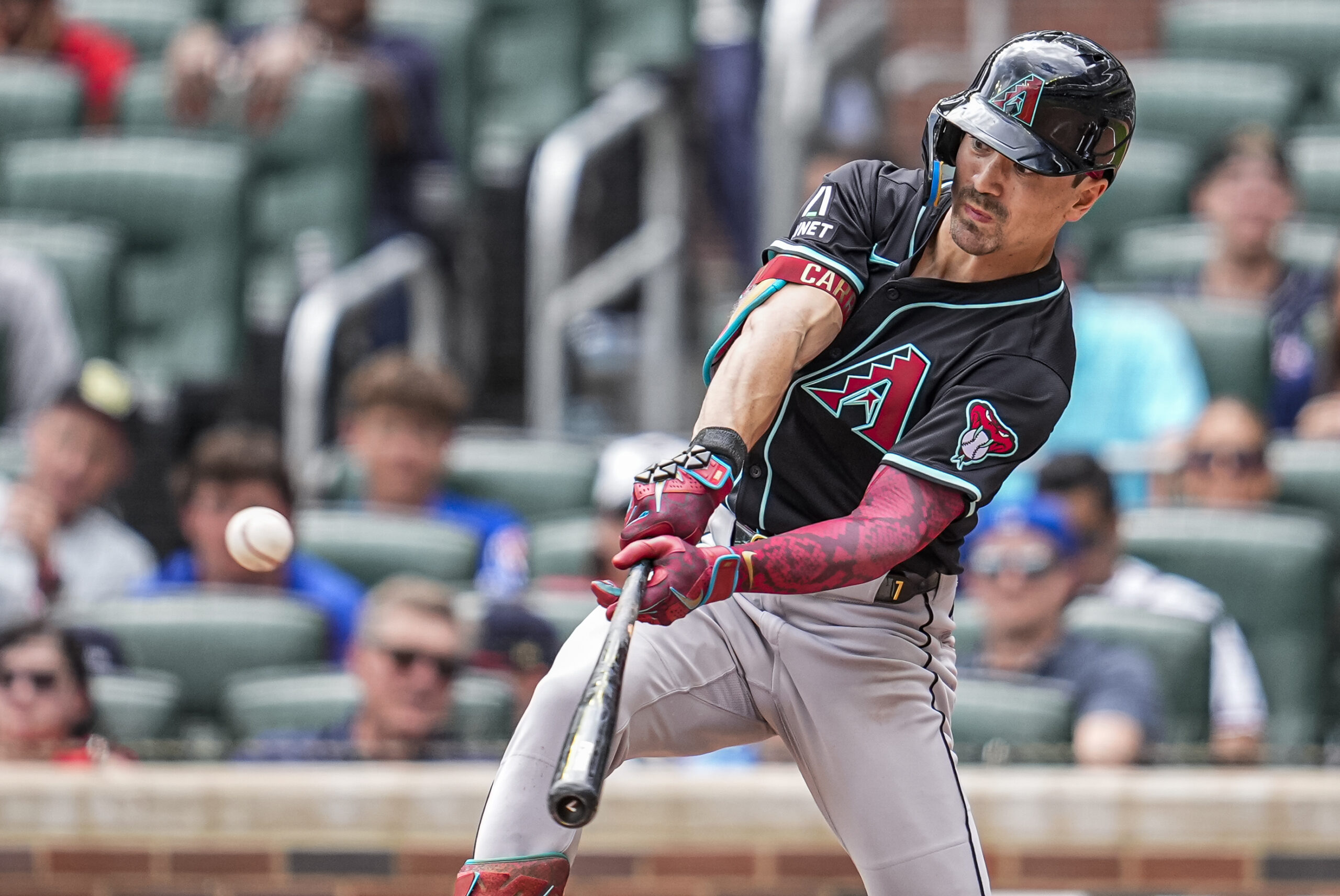 Jun 5, 2025; Cumberland, Georgia, USA; Arizona Diamondbacks right fielder Corbin Carroll (7) doubles against the Atlanta Braves during the ninth inning at Truist Park. Mandatory Credit: Dale Zanine-Imagn Images