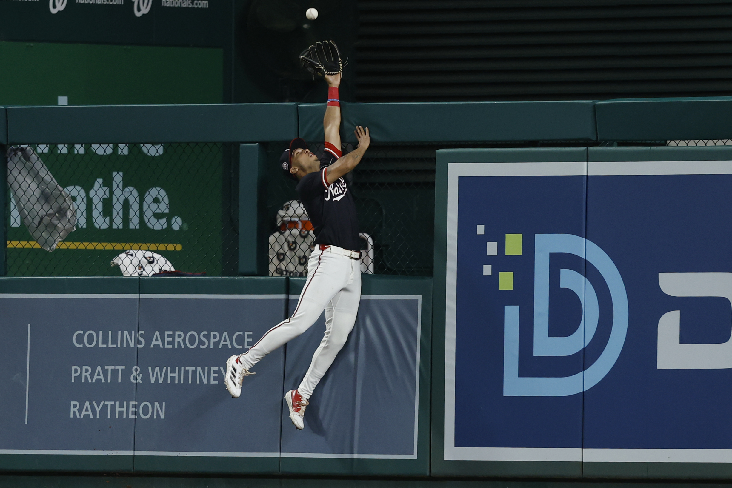 Jun 16, 2025; Washington, District of Columbia, USA; Washington Nationals outfielder Daylen Lile (51) attempts to catch a home run at the fence hit by Colorado Rockies outfielder Mickey Moniak (not pictured) during the ninth inning at Nationals Park. Mandatory Credit: Geoff Burke-Imagn Images