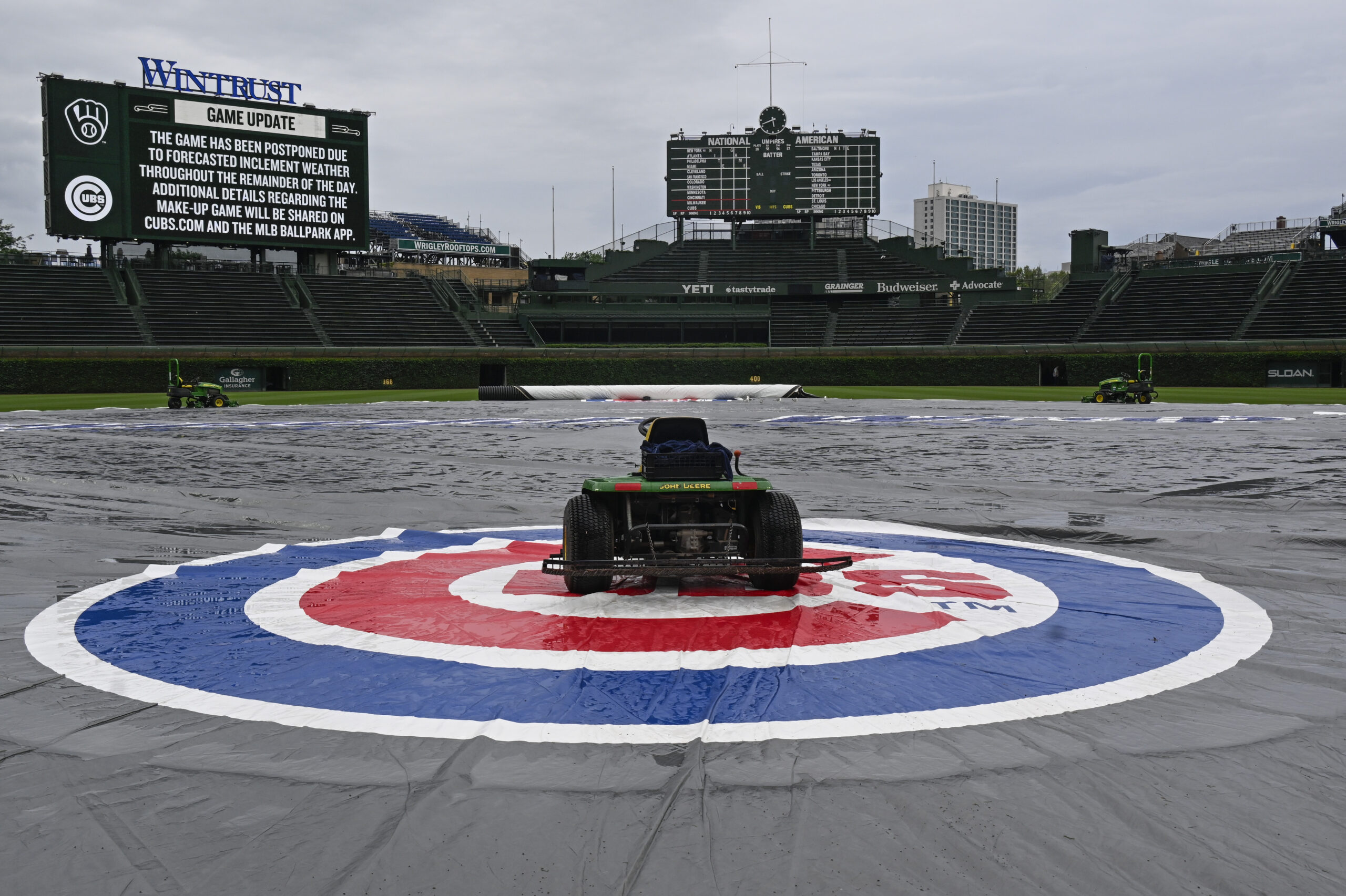 Jun 18, 2025; Chicago, Illinois, USA;  The tarp covers the field  before the weather cancelled game between the Chicago Cubs and the Milwaukee Brewers at Wrigley Field. Mandatory Credit: Matt Marton-Imagn Images