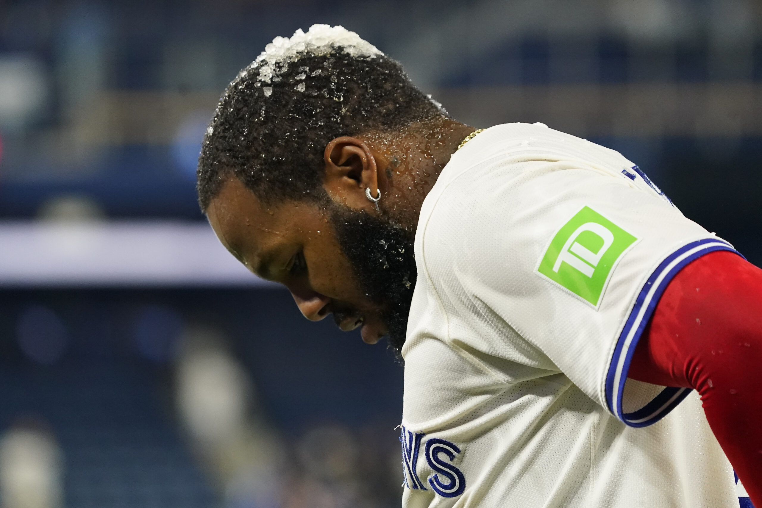 Jun 18, 2025; Toronto, Ontario, CAN; Ice sits on top of Toronto Blue Jays first baseman Vladimir Guerrero (27) after being doused with Gatorade after a win over the Arizona Diamondbacks at Rogers Centre. Mandatory Credit: John E. Sokolowski-Imagn Images