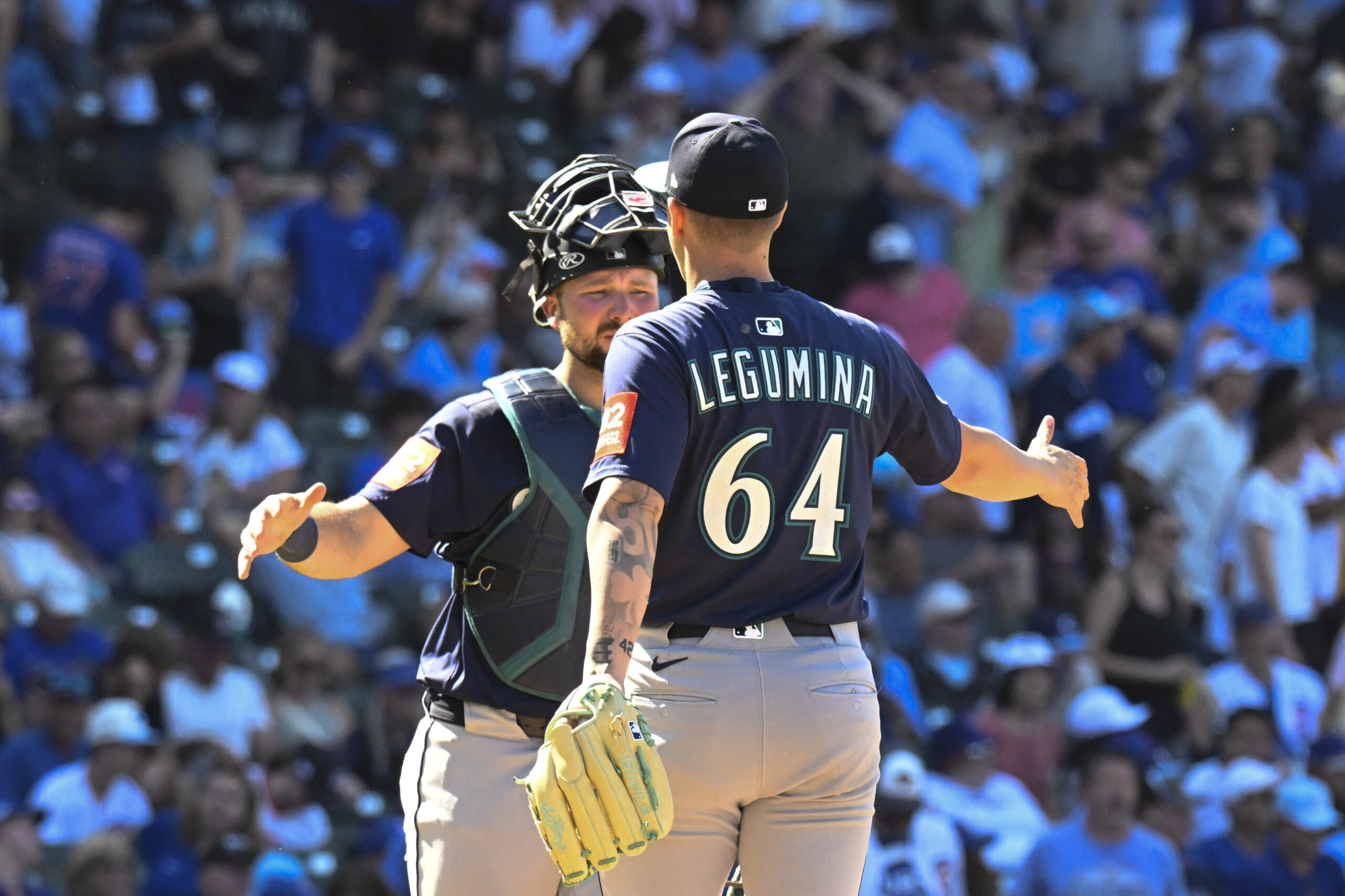 Jun 20, 2025; Chicago, Illinois, USA;  Seattle Mariners catcher Cal Raleigh (29) and pitcher Casey Legumina (64) celebrate after the game asgsinst the Chicago Cubs at Wrigley Field. Mandatory Credit: Matt Marton-Imagn Images