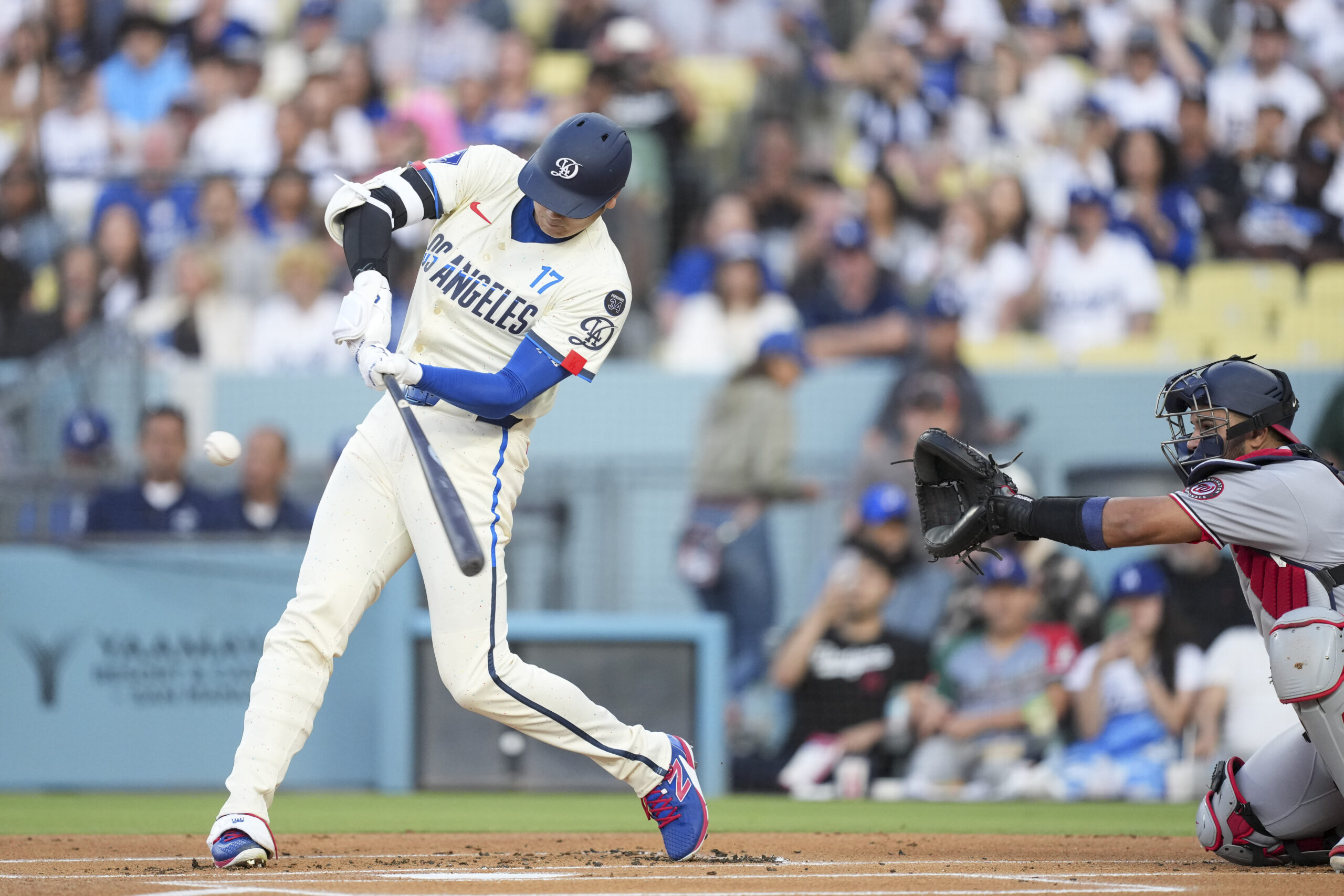 Jun 21, 2025; Los Angeles, California, USA; Los Angeles Dodgers two-way player Shohei Ohtani (17) flies out to center during the first inning against against the Washington Nationals at Dodger Stadium. Mandatory Credit: Kirby Lee-Imagn Images