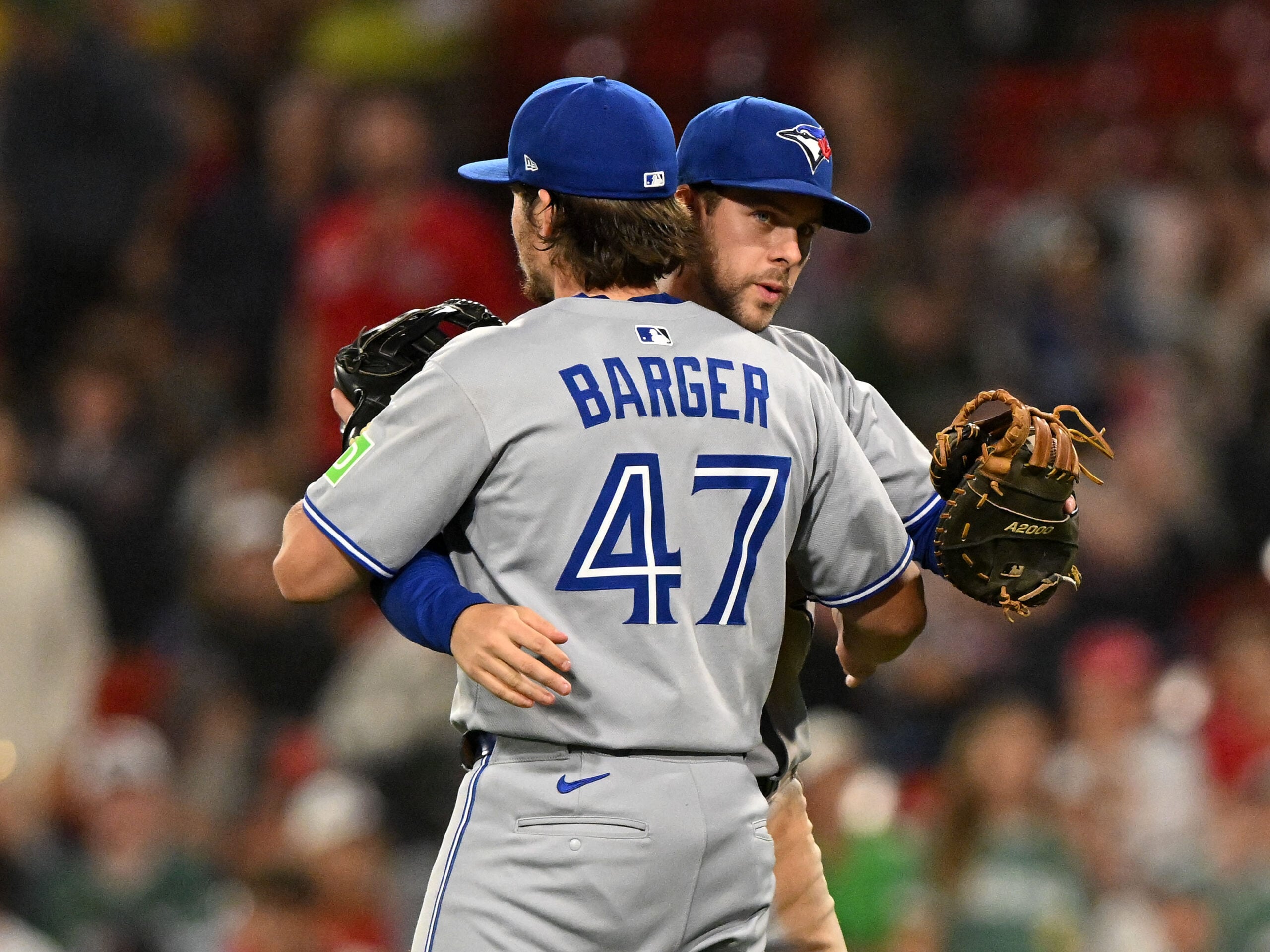 Jun 27, 2025; Boston, Massachusetts, USA; Toronto Blue Jays third baseman Addison Barger (47) celebrates with third baseman Ernie Clement (22) after a game against the Boston Red Sox at Fenway Park. Mandatory Credit: Brian Fluharty-Imagn Images