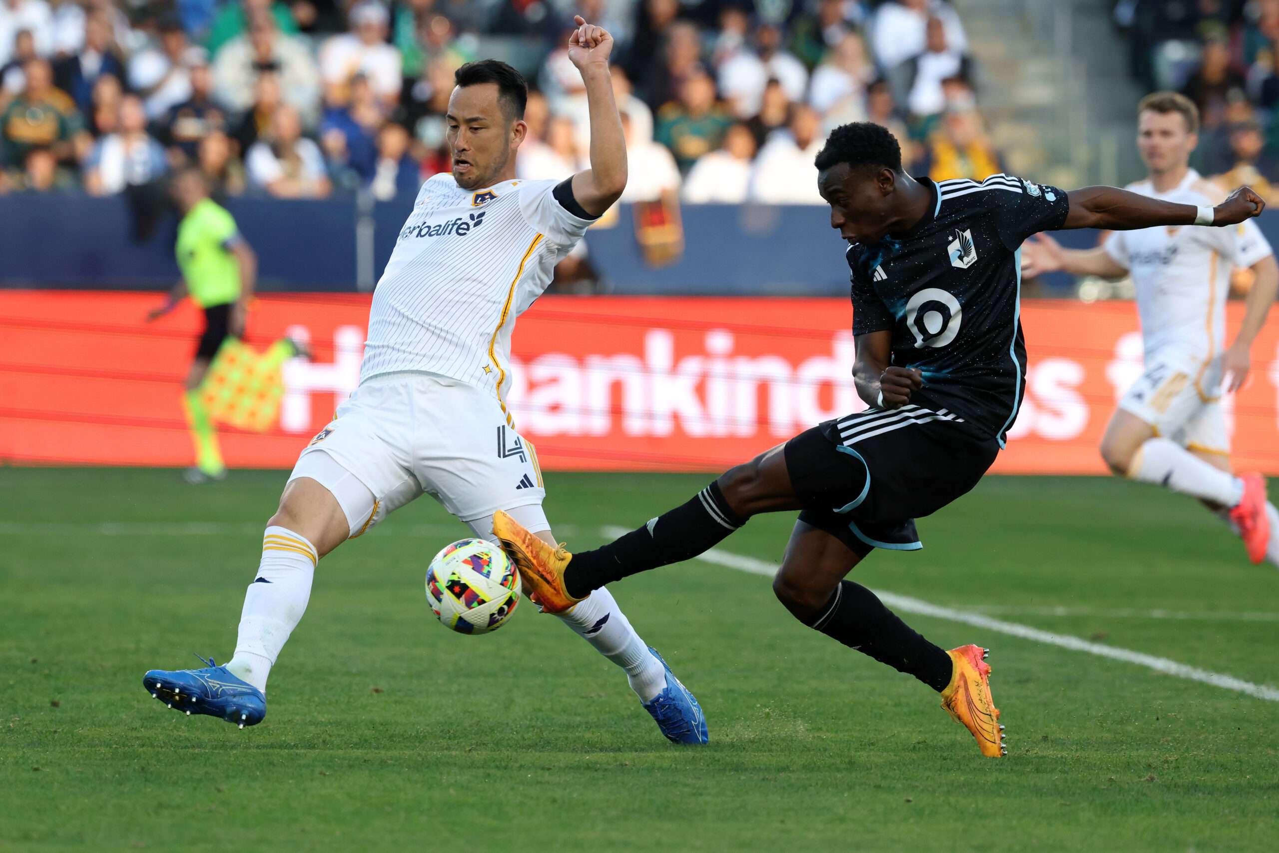 Nov 24, 2024; Carson, California, USA;  Minnesota United forward Kelvin Yeboah (9) shoots the ball as LA Galaxy defender Maya Yoshida (4) defends during the first half at Dignity Health Sports Park. Mandatory Credit: Kiyoshi Mio-Imagn Images