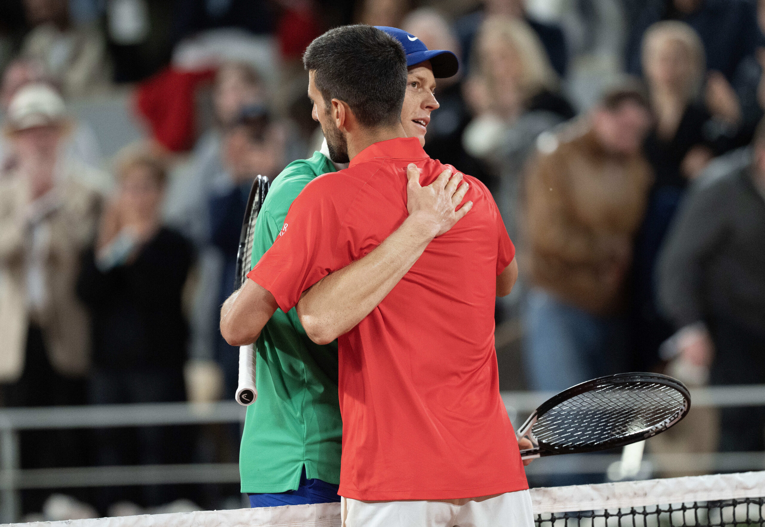 Jun 6, 2025; Paris, FR;  Jannik Sinner of Italy at the net with Novak Djokovic of Serbia  after their match on day 13 at Roland Garros Stadium. Mandatory Credit: Susan Mullane-Imagn Images