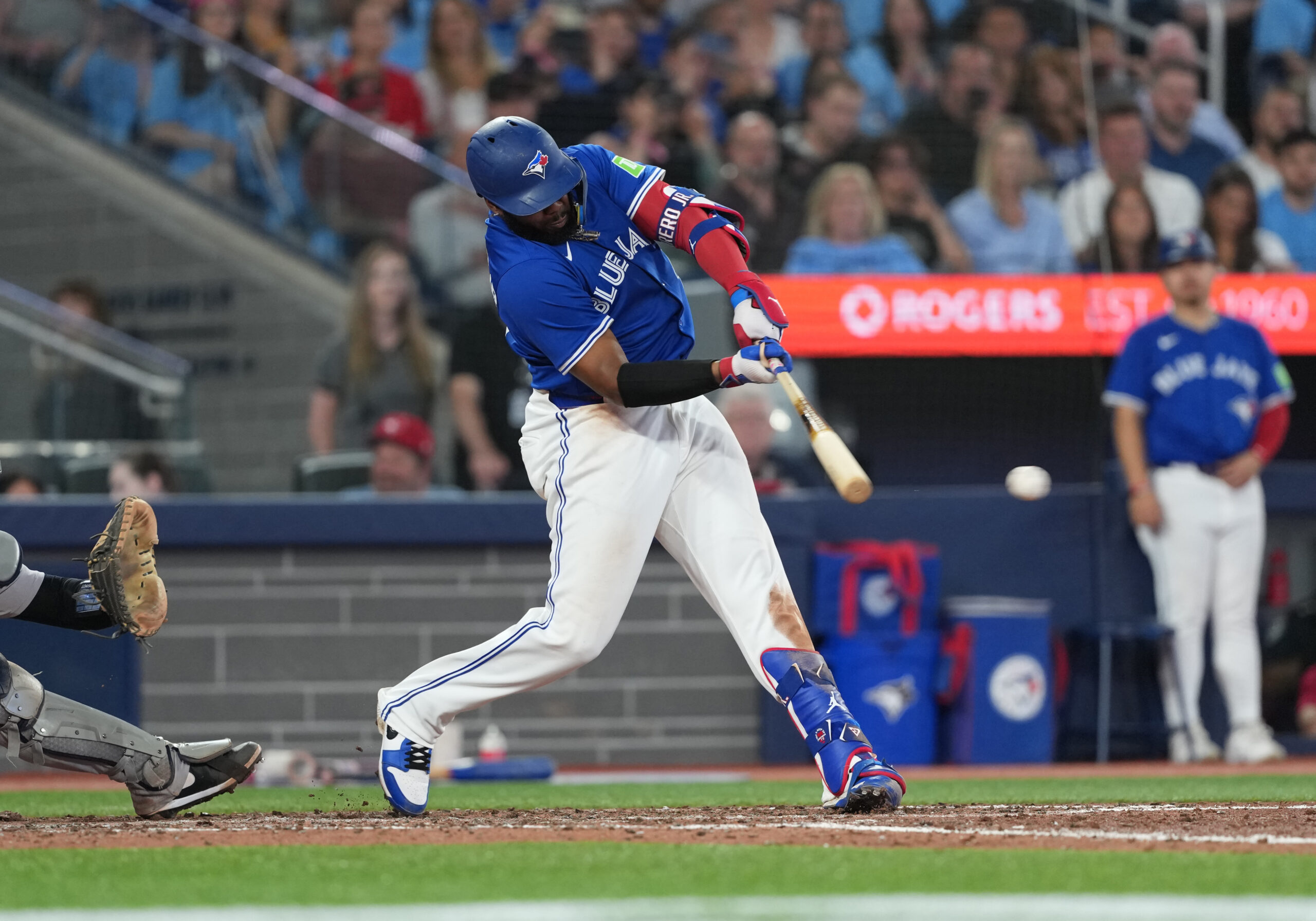 Jun 30, 2025; Toronto, Ontario, CAN; Toronto Blue Jays first baseman Vladimir Guerrero Jr. (27) hits a two-run double against the New York Yankees during the sixth inning at Rogers Centre. Mandatory Credit: Nick Turchiaro-Imagn Images
