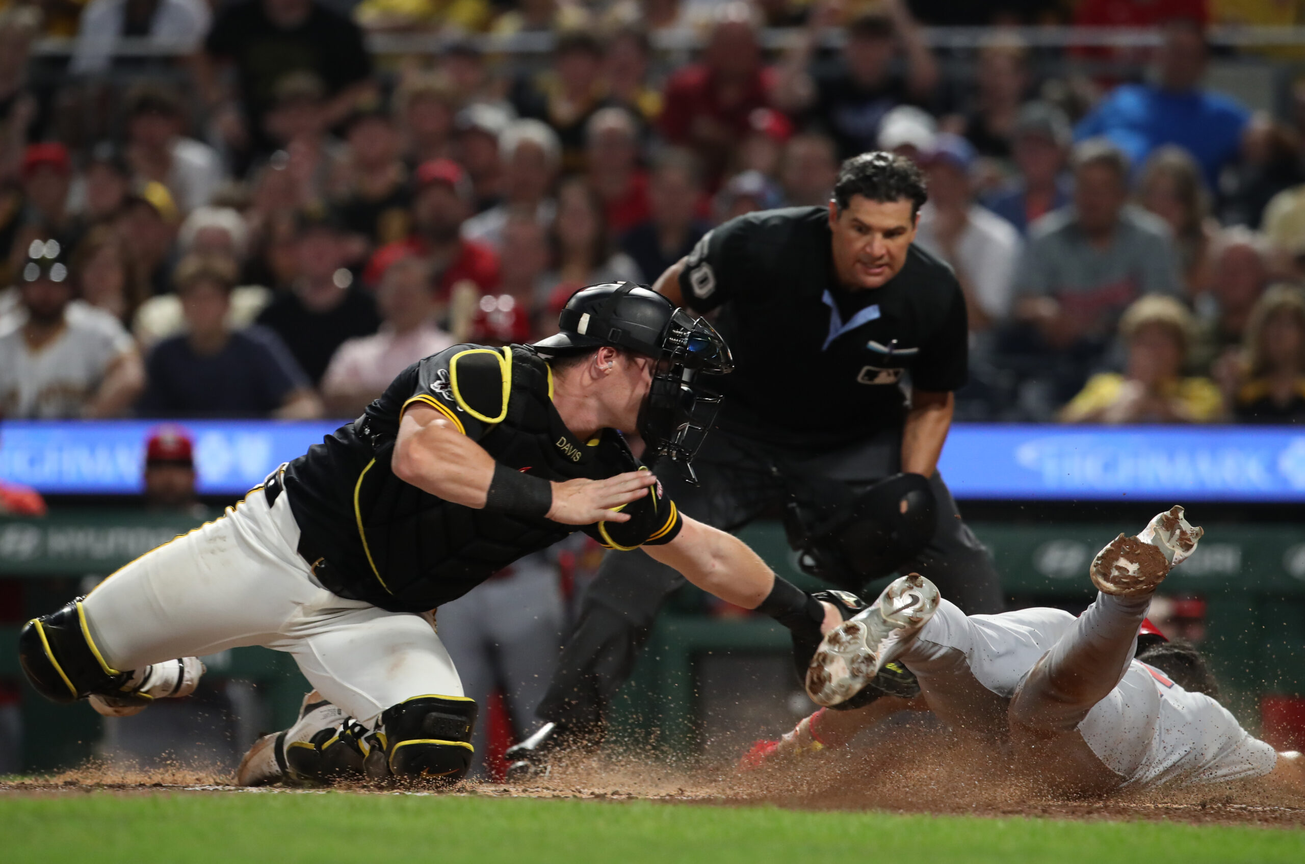 Jul 1, 2025; Pittsburgh, Pennsylvania, USA;  Pittsburgh Pirates catcher Henry Davis (32) tags St. Louis Cardinals designated hitter Jose Fermin (right) out at home plate attempting to score during the ninth inning at PNC Park. Mandatory Credit: Charles LeClaire-Imagn Images