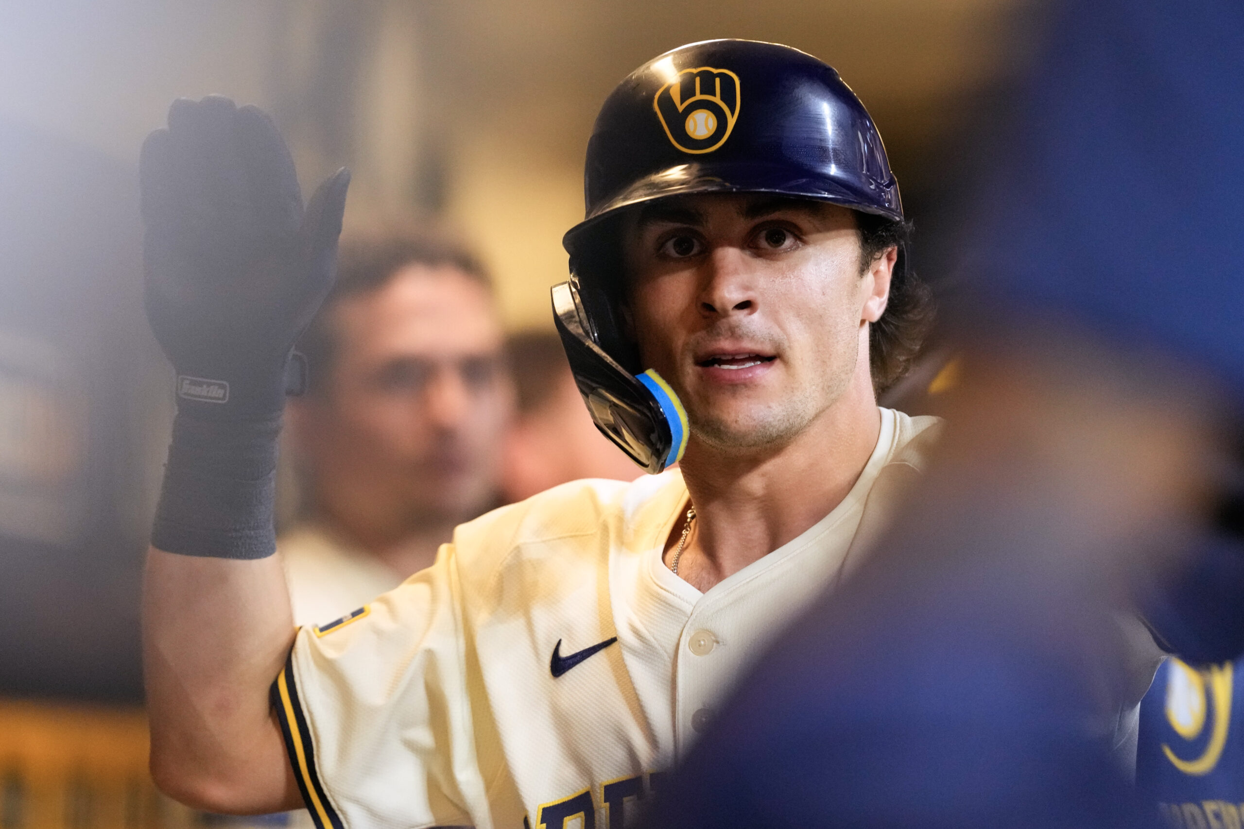 Jul 8, 2025; Milwaukee, Wisconsin, USA;  Milwaukee Brewers right fielder Sal Frelick (10) high fives teammates in the dugout after hitting a home run during the eighth inning against the Los Angeles Dodgers at American Family Field. Mandatory Credit: Jeff Hanisch-Imagn Images