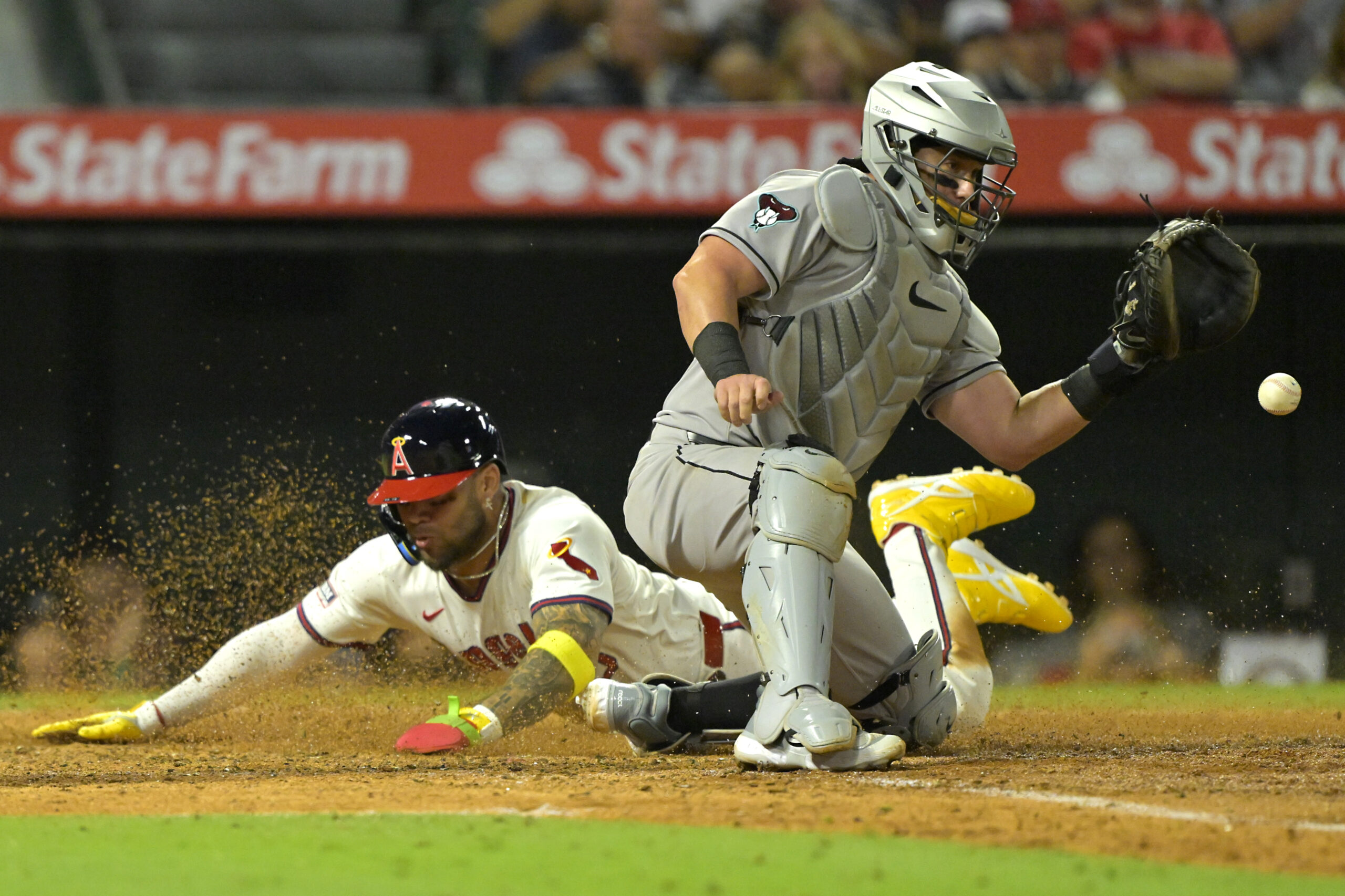 Jul 12, 2025; Anaheim, California, USA;   Los Angeles Angels third baseman Yoan Moncada (5) beats the throw to Arizona Diamondbacks as he scores on a single by shortstop Zach Neto (9) in the eighth inning at Angel Stadium. Mandatory Credit: Jayne Kamin-Oncea-Imagn Images