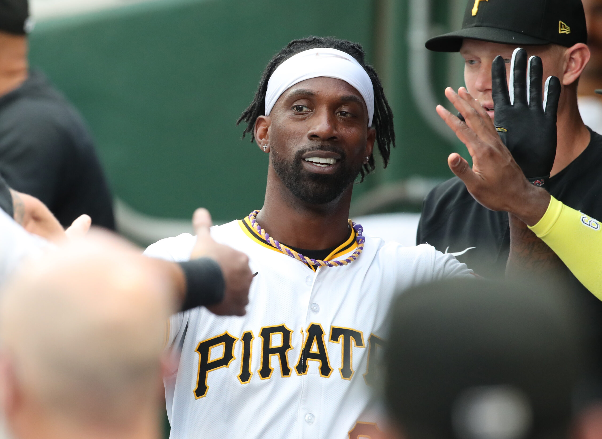 Jul 20, 2025; Pittsburgh, Pennsylvania, USA;  Pittsburgh Pirates designated hitter Andrew McCutchen (22) high-fives in the dugout after scoring a run against the Chicago White Sox at PNC Park. Mandatory Credit: Charles LeClaire-Imagn Images