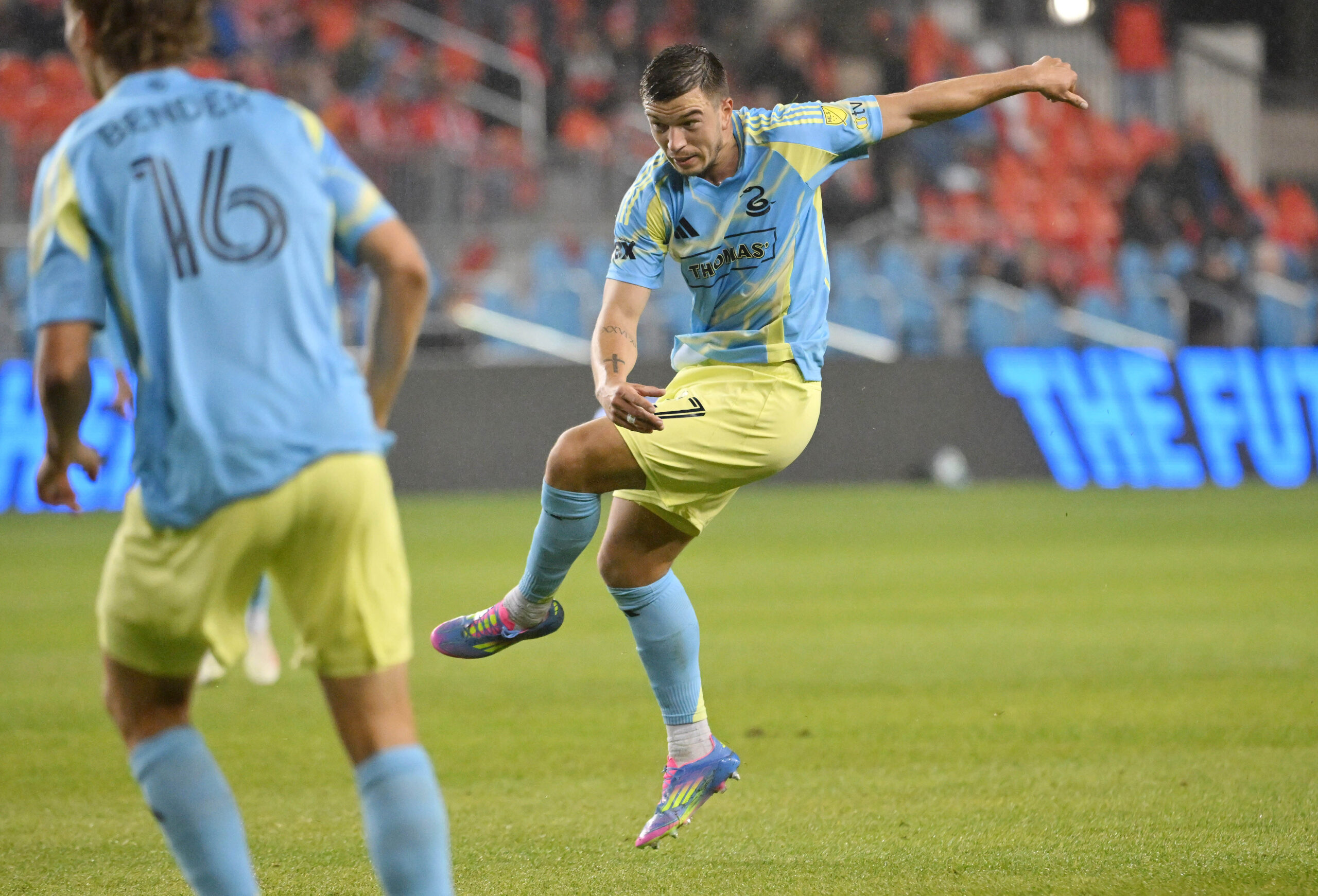 May 28, 2025; Toronto, Ontario, CAN;  Philadelphia Union defender Kai Wagner (27) shoots the ball to score the winning goal against Toronto FC in the second half at BMO Field. Mandatory Credit: Dan Hamilton-Imagn Images