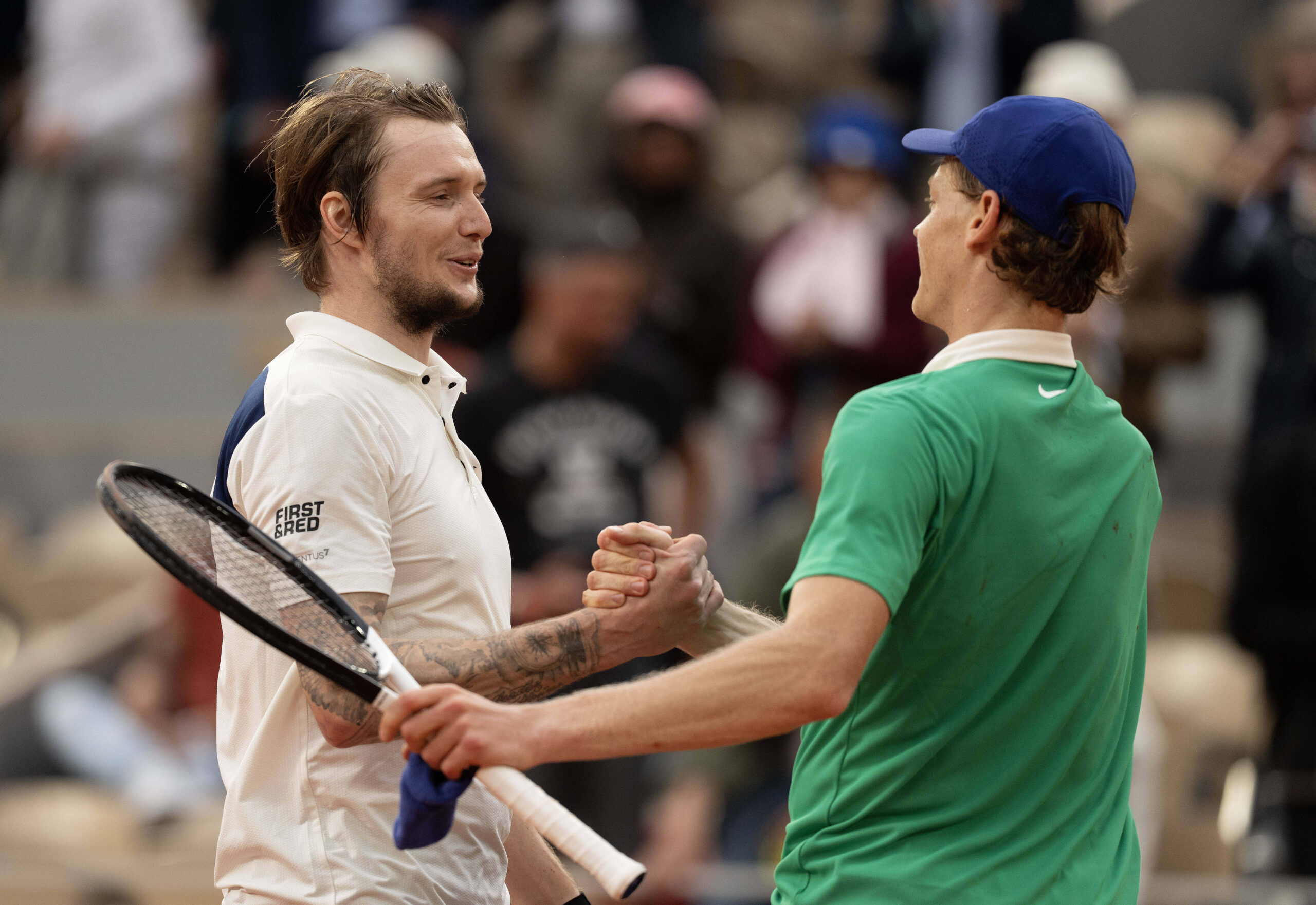 Jun 4, 2025; Paris, FR; Jannik Sinner of Italy at the net with Alexander Bublik of Kazakhstan after their match on day 11 at Roland Garros Stadium.  Mandatory Credit: Susan Mullane-Imagn Images