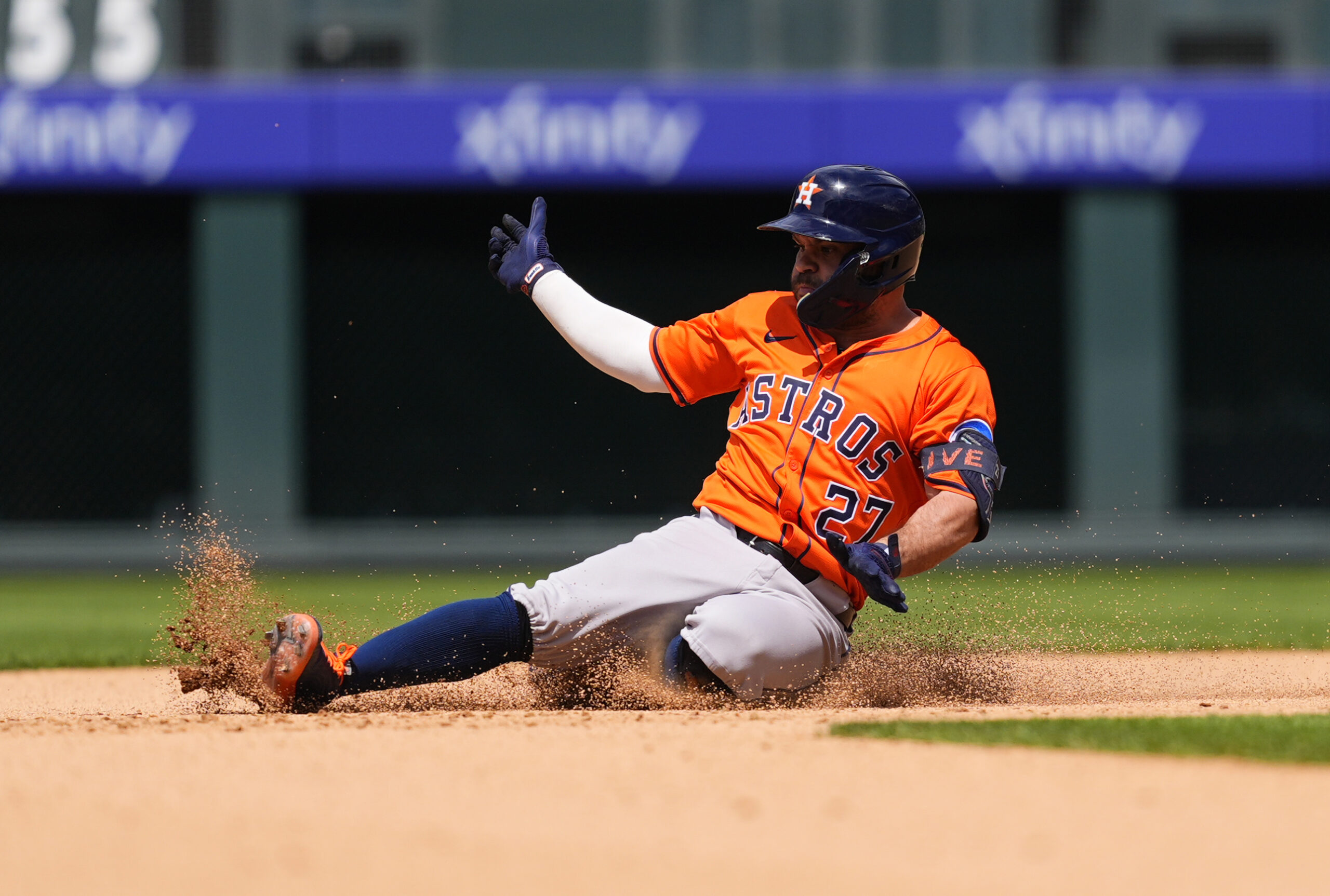 Jul 3, 2025; Denver, Colorado, USA; Houston Astros designated hitter Jose Altuve (27) slides for a double in the seventh inning against the Colorado Rockies  at Coors Field. Mandatory Credit: Ron Chenoy-Imagn Images