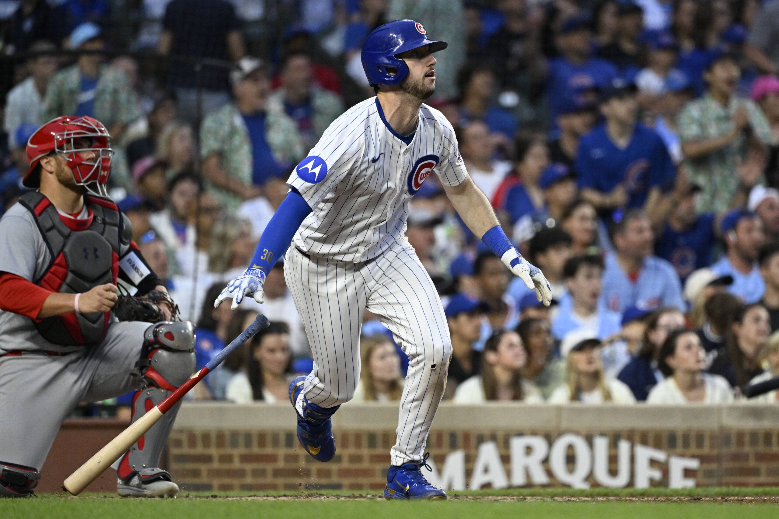 Jul 6, 2025; Chicago, Illinois, USA;  Chicago Cubs outfielder Kyle Tucker (30) hits an RBI sacrifice fly ball during the third inning against the St. Louis Cardinals at Wrigley Field. Mandatory Credit: Matt Marton-Imagn Images