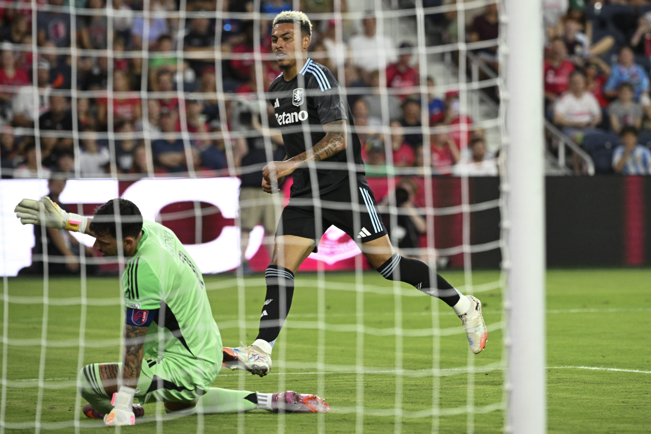 Jul 30, 2025; St. Louis, Missouri, USA; Aston Villa midfielder Morgan Rogers (27) watches the ball go past St. Louis City goalkeeper Roman Burki (1) for a goal in the first half at Energizer Park. Mandatory Credit: Joe Puetz-Imagn Images
