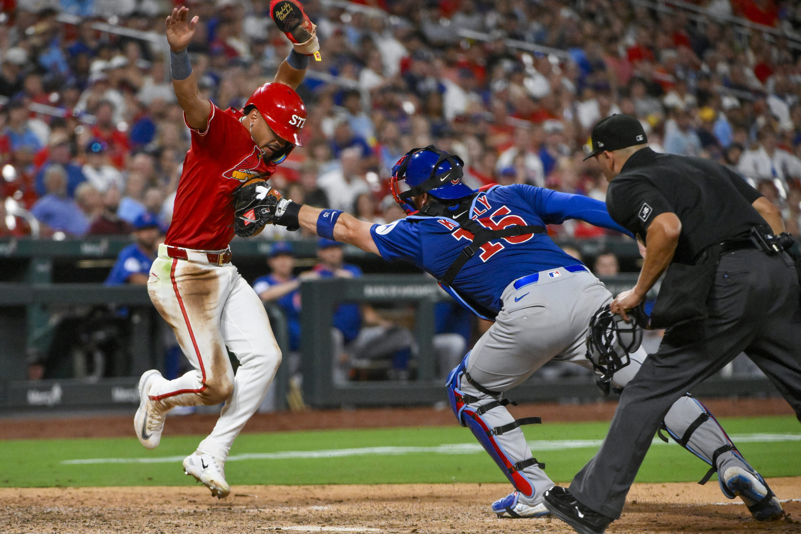 Aug 8, 2025; St. Louis, Missouri, USA;  St. Louis Cardinals shortstop Masyn Winn (0) is tagged out by Chicago Cubs catcher Carson Kelly (15) during the eighth inning at Busch Stadium. Mandatory Credit: Jeff Curry-Imagn Images