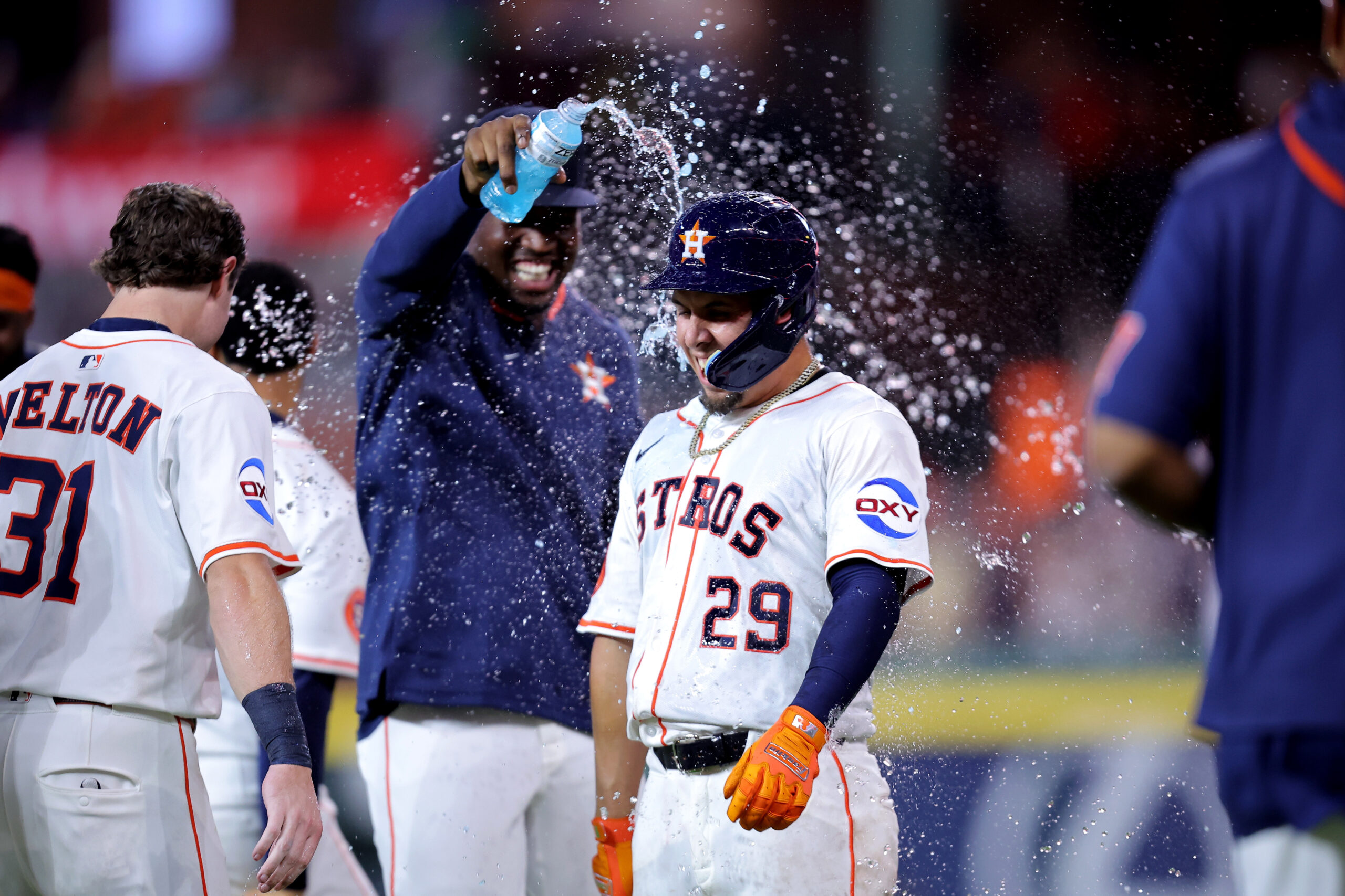 Aug 16, 2025; Houston, Texas, USA; Houston Astros second baseman Ramon Urias (29) is congratulated by teammates after hitting into a fielder's choice to score the winning run against the Baltimore Orioles during the 12th inning at Daikin Park. Mandatory Credit: Erik Williams-Imagn Images