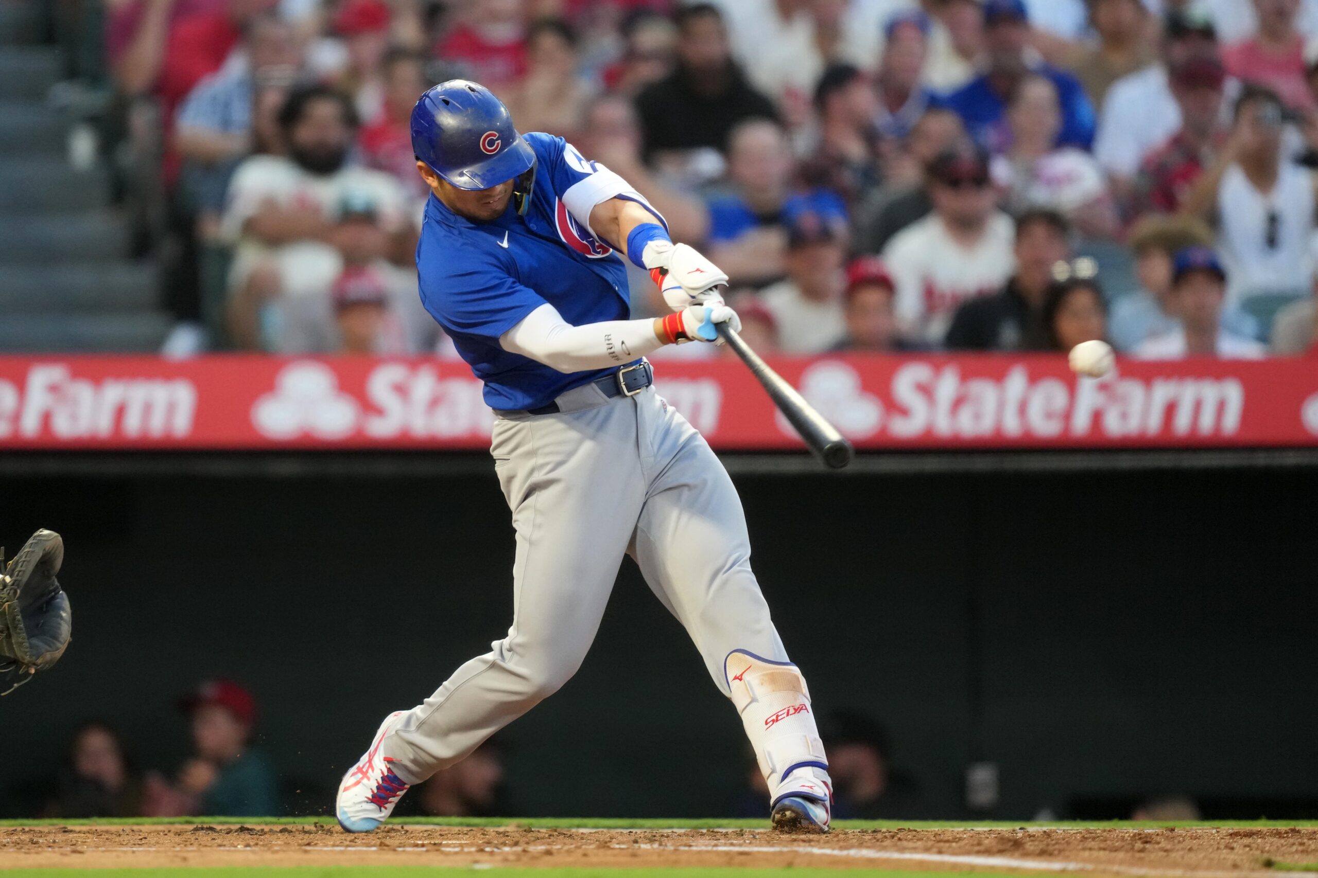 Aug 22, 2025; Anaheim, California, USA; Chicago Cubs designated hitter Seiya Suzuki (27) hits a RBI sacrifice fly in the third inning against the Los Angeles Angels at Angel Stadium. Mandatory Credit: Kirby Lee-Imagn Images