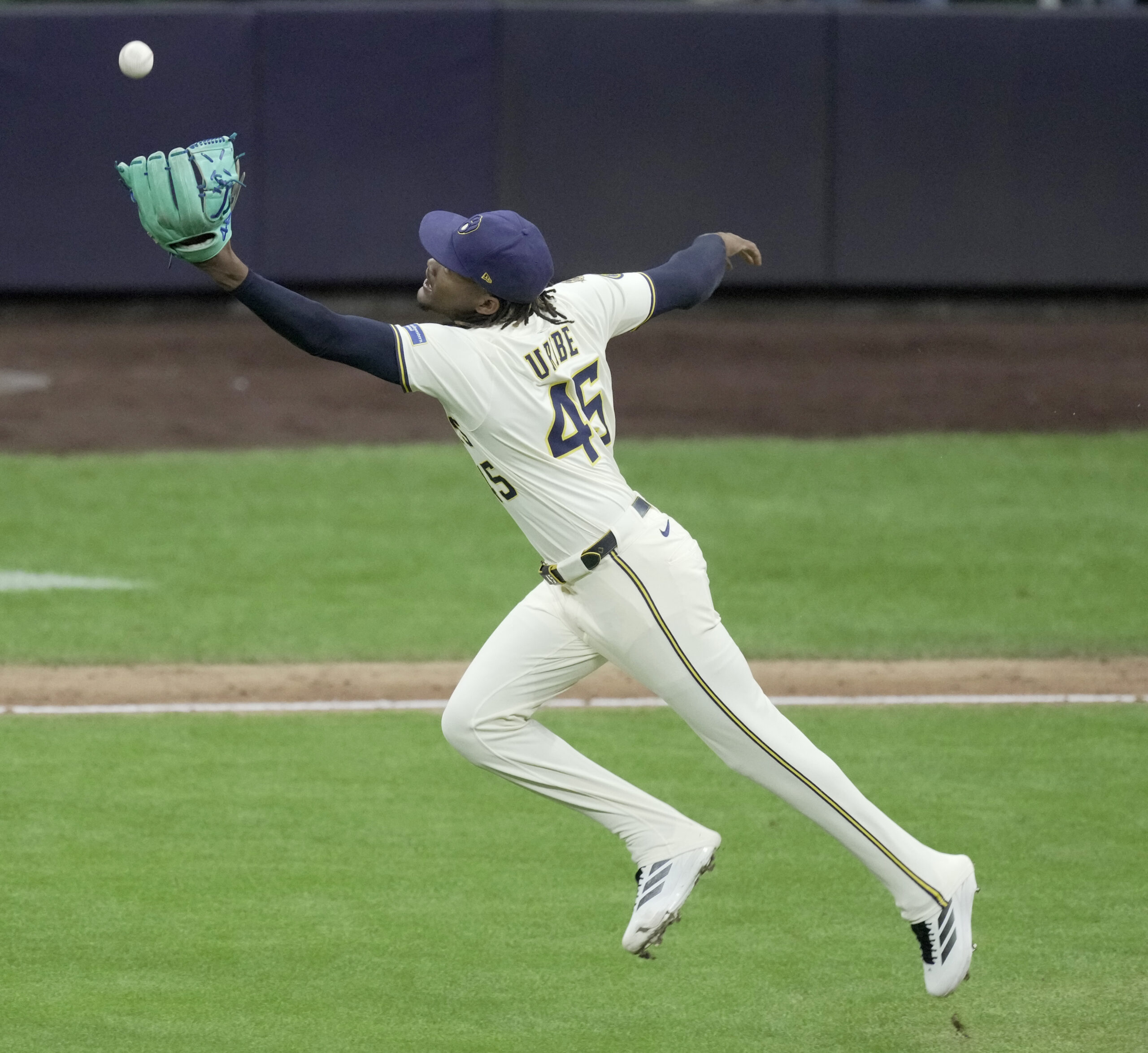 Aug 25, 2025; Milwaukee, Wisconsin, USA; Milwaukee Brewers pitcher Abner Uribe (45) fields and make the throw for the final out during the ninth inning of their game against the Arizona Diamondbacks at American Family Field. Mandatory Credit: Mark Hoffman/USA Today Network via Imagn Images