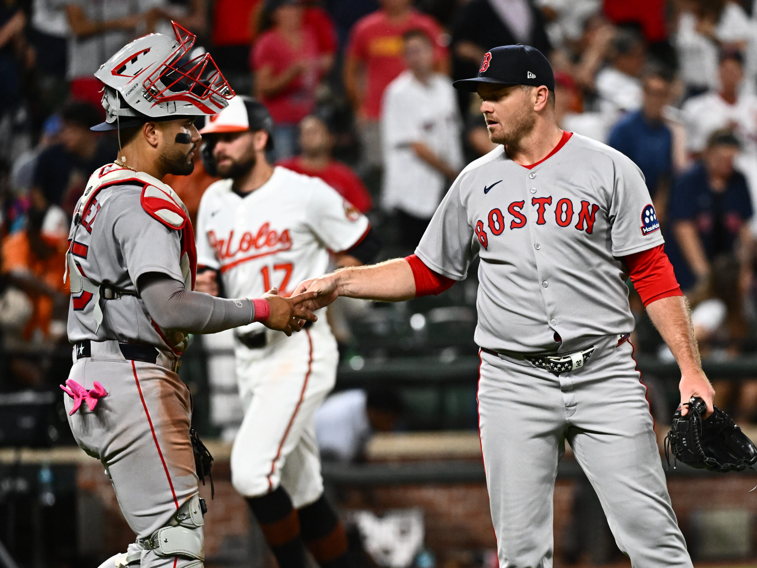 Aug 26, 2025; Baltimore, Maryland, USA; Boston Red Sox pitcher Justin Wilson (right) and catcher Carlos Narvaez (left) celebrate the win against the Baltimore Orioles at Oriole Park at Camden Yards. Mandatory Credit: James A. Pittman-Imagn Images