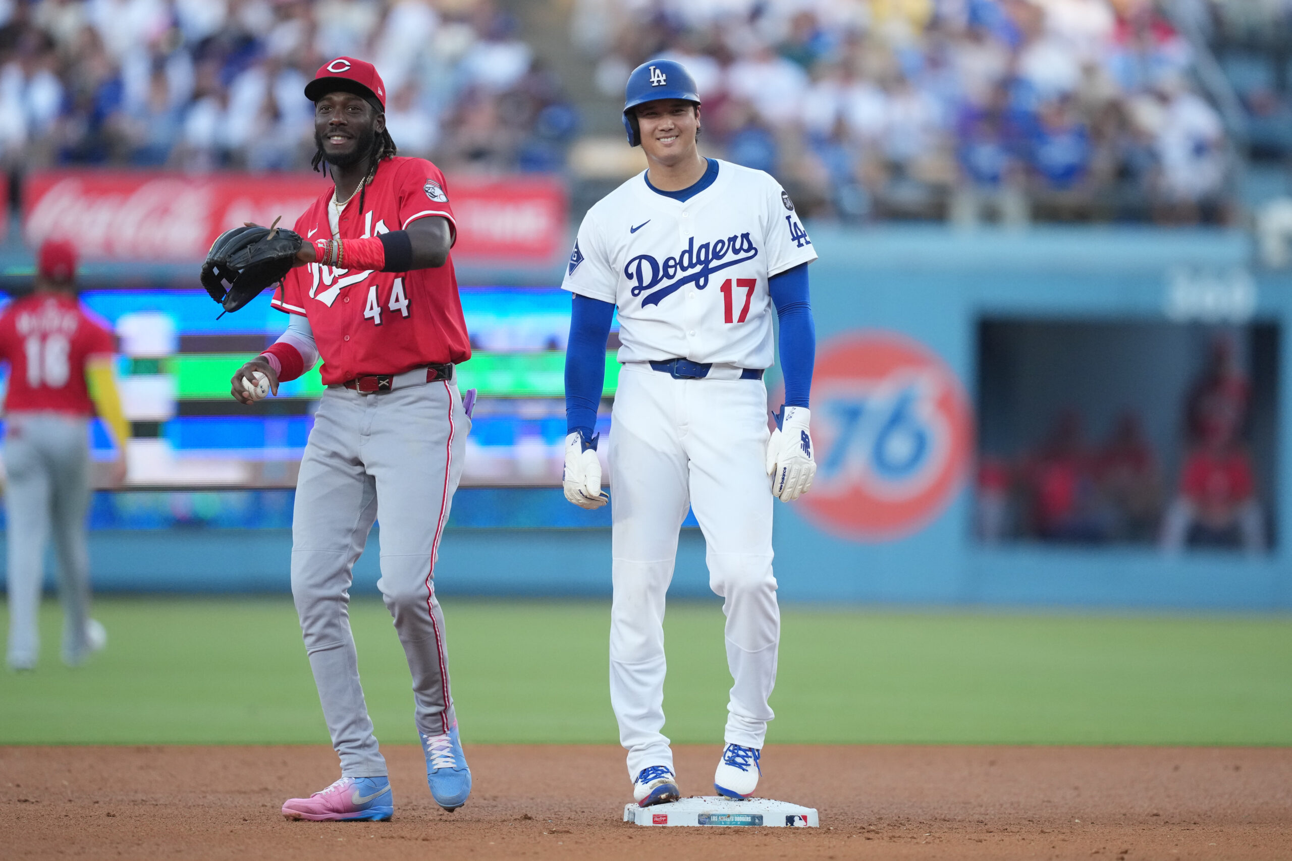 Aug 27, 2025; Los Angeles, California, USA;  Los Angeles Dodgers starting pitcher Shohei Ohtani (17) is held at second base by Cincinnati Reds shortstop Elly De La Cruz (44) in the fourth inning at Dodger Stadium. Mandatory Credit: Kirby Lee-Imagn Images