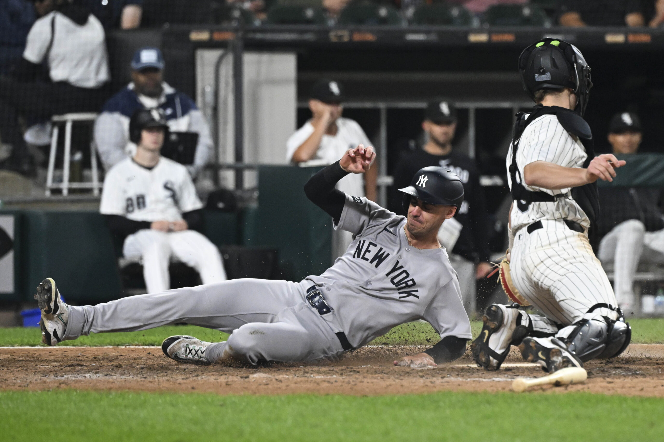Aug 28, 2025; Chicago, Illinois, USA; New York Yankees outfielder Cody Bellinger (35) slides safely past Chicago White Sox catcher Kyle Teel (8) during the ninth inning at Rate Field. Mandatory Credit: Matt Marton-Imagn Images
