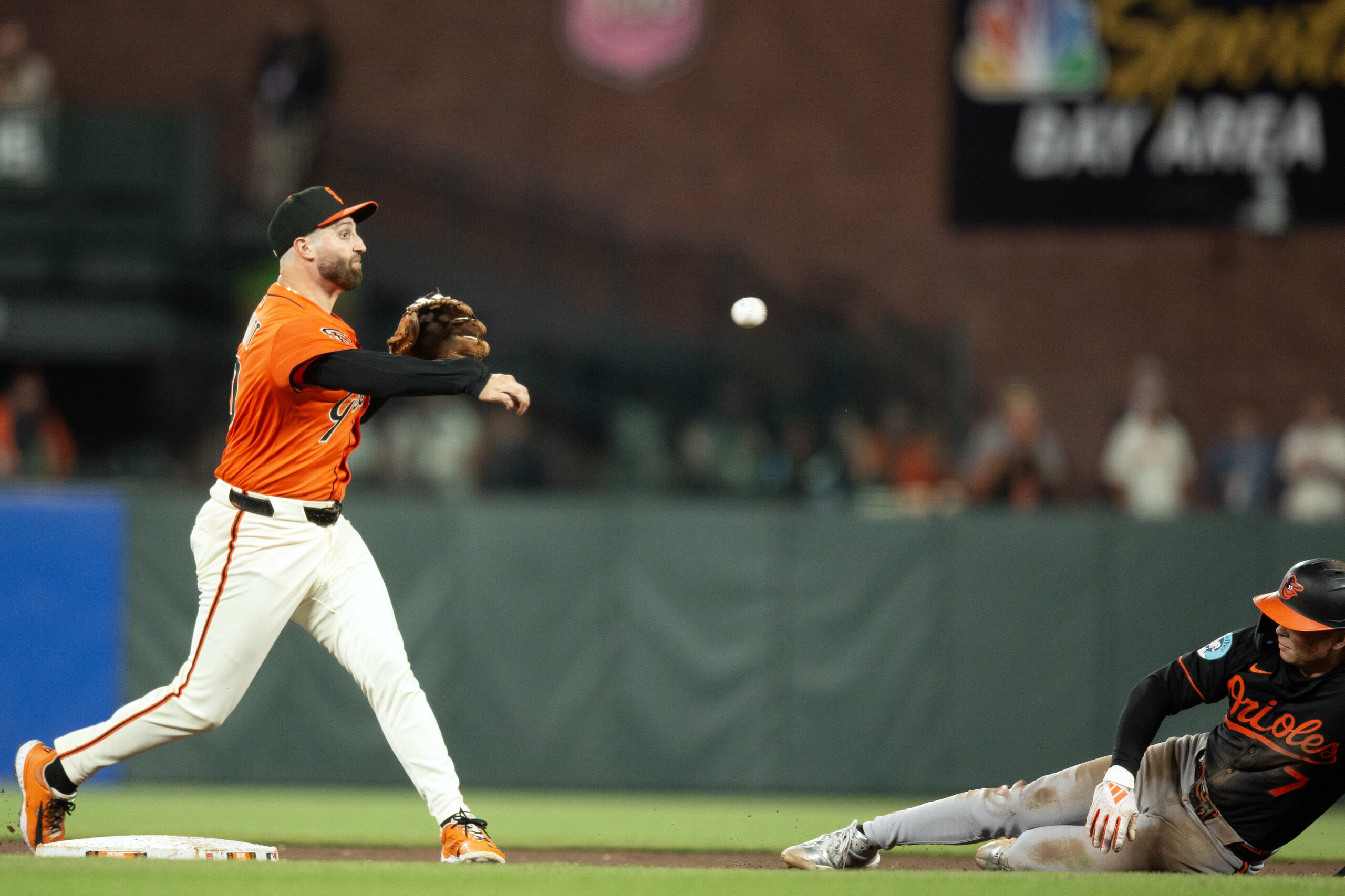 Aug 29, 2025; San Francisco, California, USA; San Francisco Giants second baseman Casey Schmitt (10) throws over Baltimore Orioles second baseman Jackson Holliday (7) too late to complete a double play during the ninth inning at Oracle Park. Mandatory Credit: D. Ross Cameron-Imagn Images