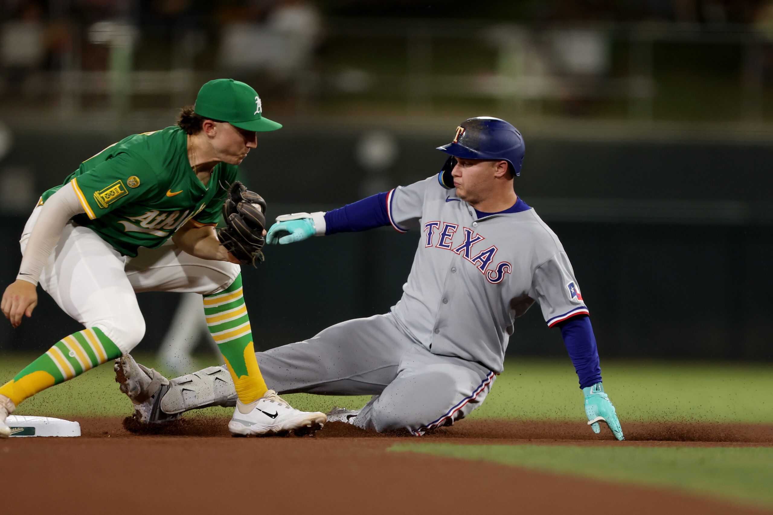 Aug 30, 2025; West Sacramento, California, USA; Texas Rangers designated hitter Joc Pederson (4) slides ahead of Athletics second baseman Zack Gelof’s tag (left) during the seventh inning at Sutter Health Park. Mandatory Credit: Dennis Lee-Imagn Images