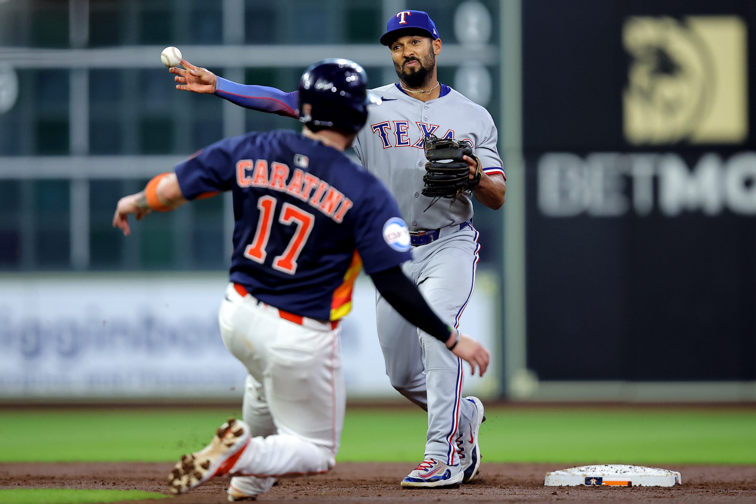 Jul 13, 2025; Houston, Texas, USA; Texas Rangers second baseman Marcus Semien (2) throws a fielded ball to first base to complete a double play against the Houston Astros during the second inning at Daikin Park. Mandatory Credit: Erik Williams-Imagn Images