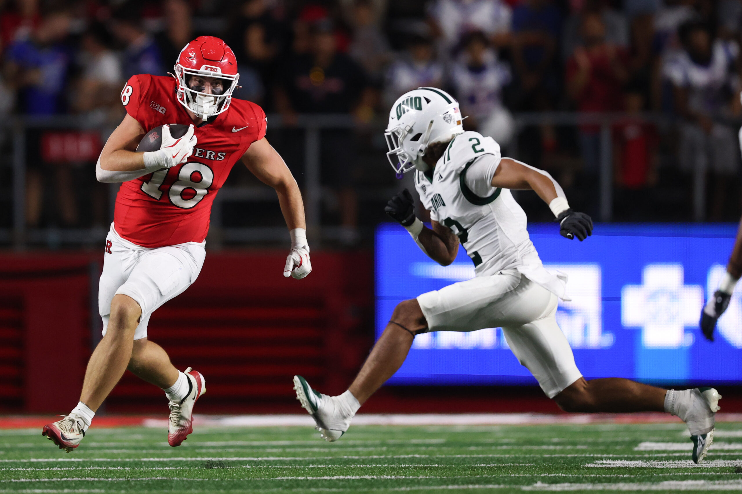 Aug 28, 2025; Piscataway, New Jersey, USA;  Rutgers Scarlet Knights tight end Colin Weber (18) gains yards after catch as Ohio Bobcats safety DJ Walker (2) pursues during the second half at SHI Stadium. Mandatory Credit: Vincent Carchietta-Imagn Images