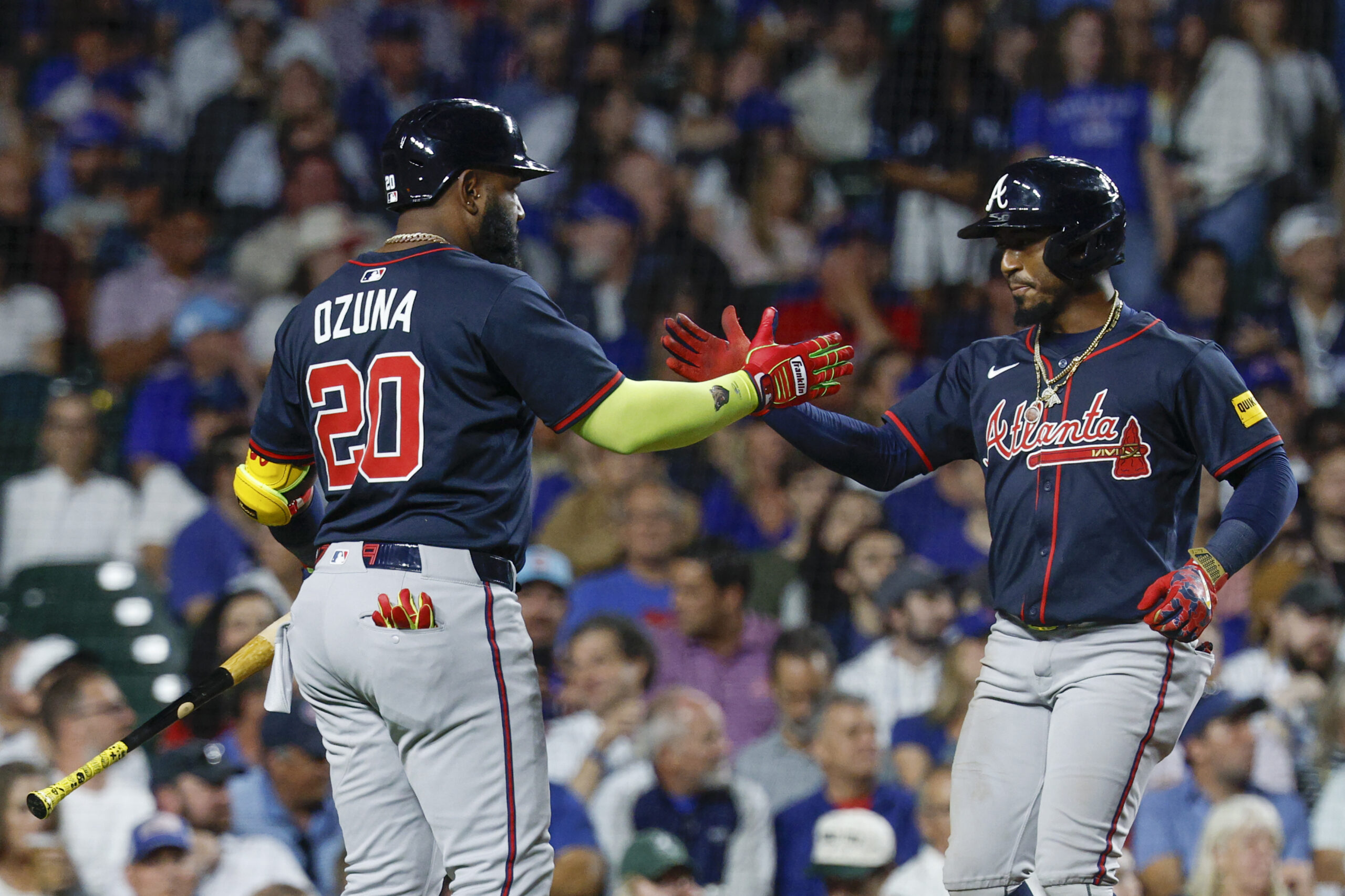 Sep 5, 2025; Chicago, Illinois, USA; Atlanta Braves second baseman Ozzie Albies (1) celebrates with designated hitter Marcell Ozuna (20) after hitting a solo home run against the Chicago Cubs during the fourth inning at Wrigley Field. Mandatory Credit: Kamil Krzaczynski-Imagn Images