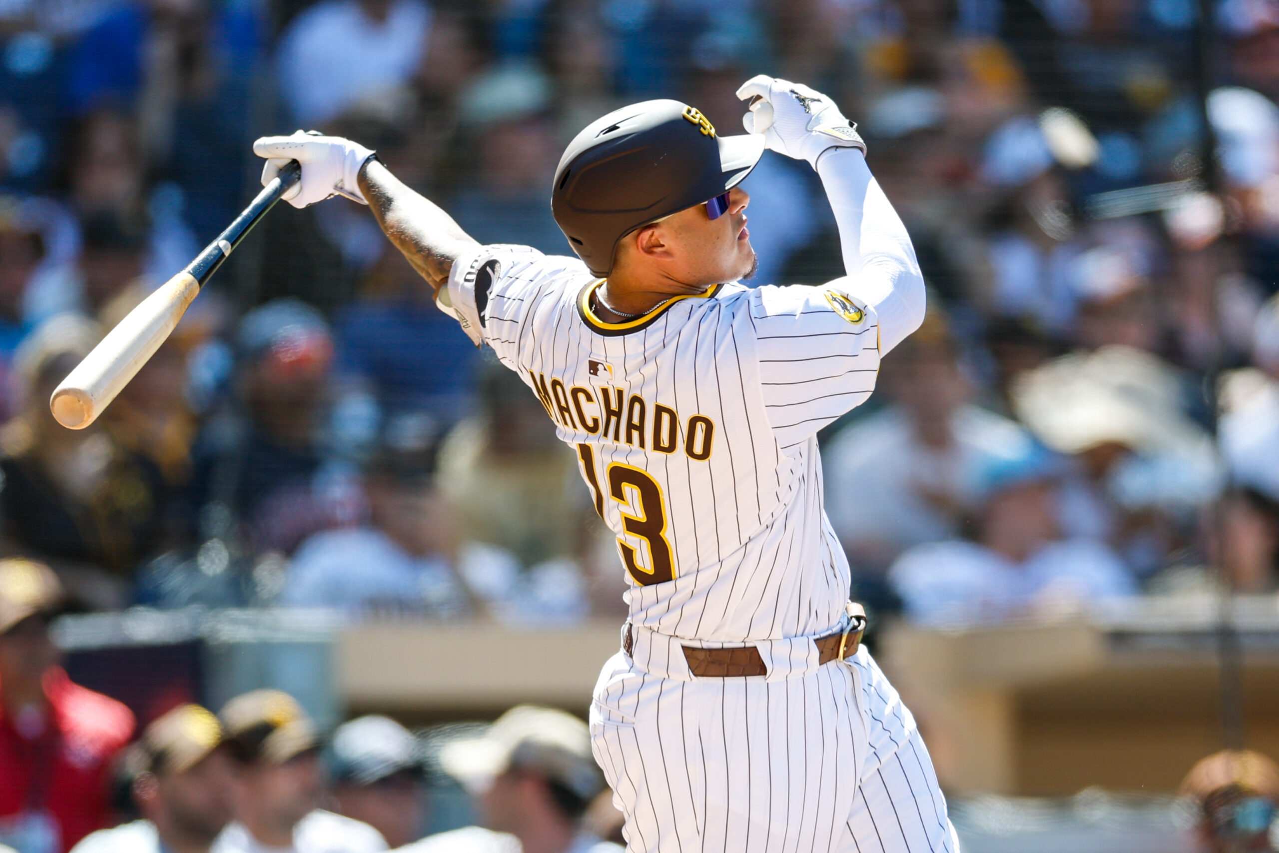 Sep 3, 2025; San Diego, California, USA; San Diego Padres third baseman Manny Machado (13) hits a two-run home run during the sixth inning against the Baltimore Orioles at Petco Park. Mandatory Credit: David Frerker-Imagn Images