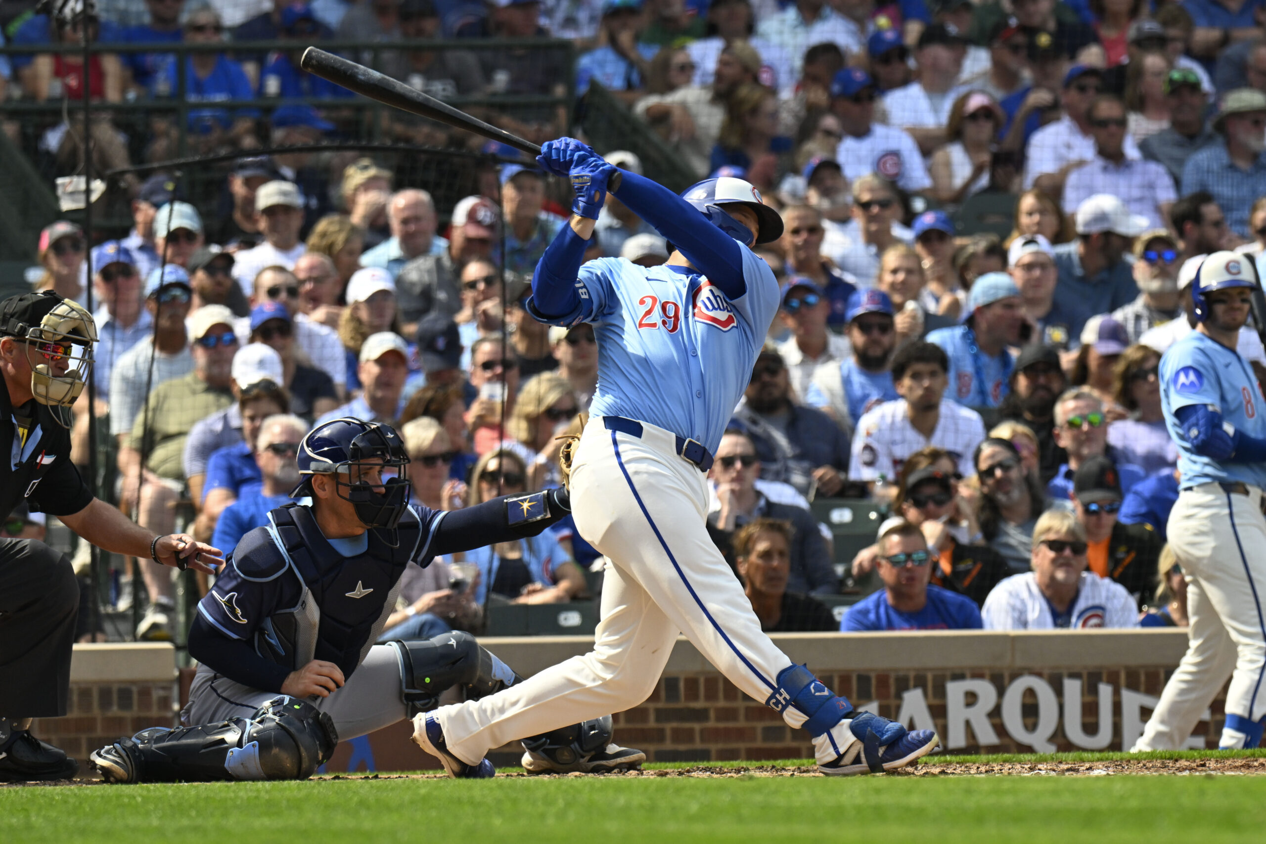 Sep 12, 2025; Chicago, Illinois, USA;  Chicago Cubs first baseman Michael Busch (29) hits an RBI single against the Tampa Bay Rays during the second inning at Wrigley Field. Mandatory Credit: Matt Marton-Imagn Images