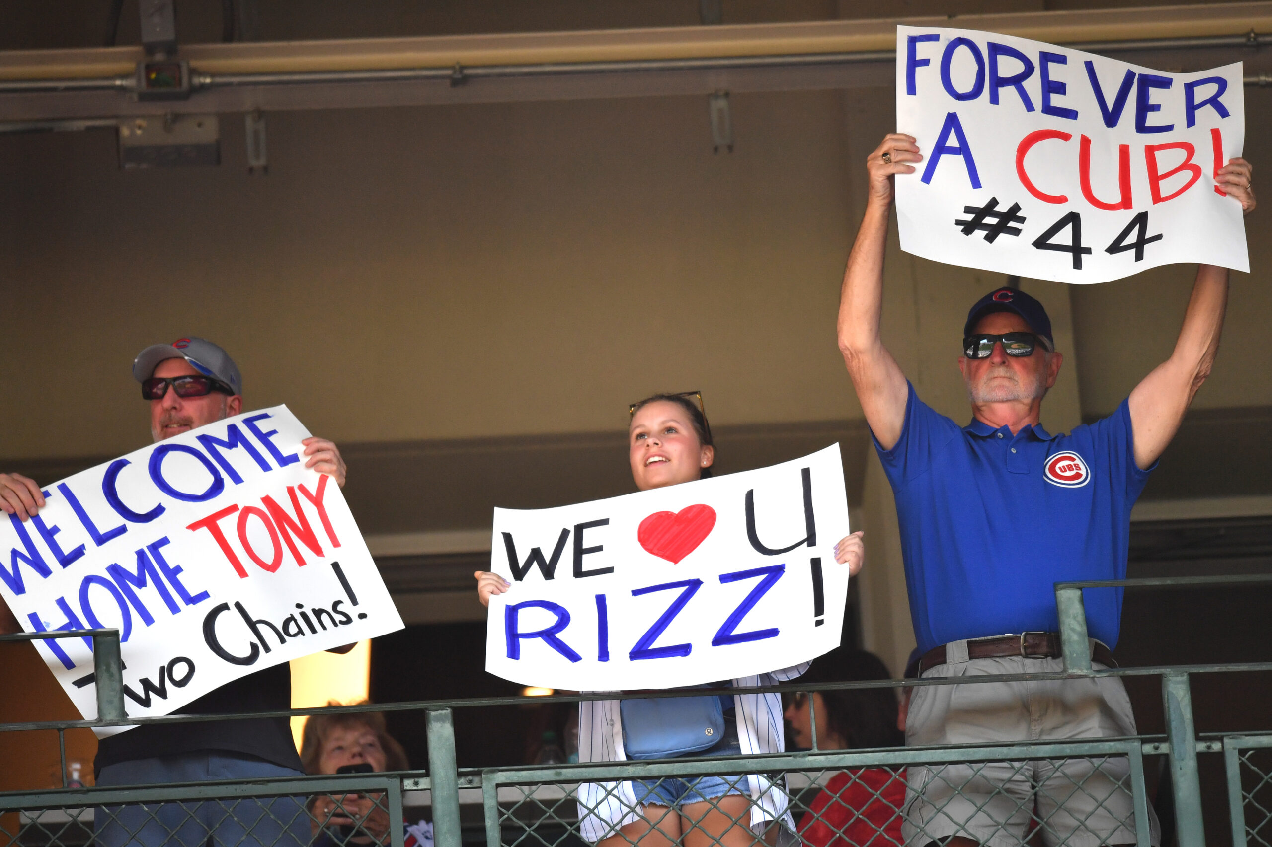 Sep 13, 2025; Chicago, Illinois, USA; Fans hold up signs for former Chicago Cubs player Anthony Rizzo during a game against the Tampa Bay Rays at Wrigley Field. Mandatory Credit: Patrick Gorski-Imagn Images