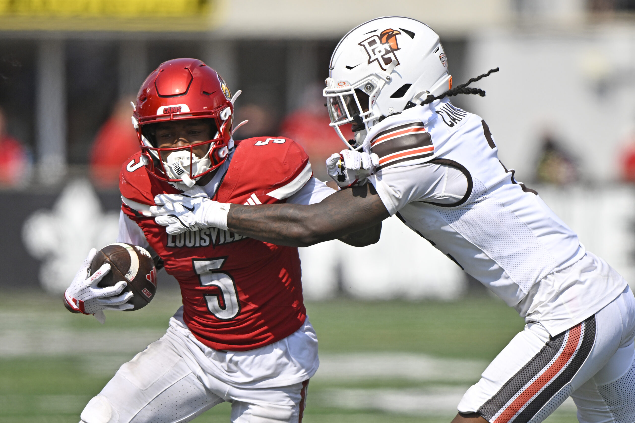 Sep 20, 2025; Louisville, Kentucky, USA;  Louisville Cardinals wide receiver Caullin Lacy (5) is defended by Bowling Green Falcons cornerback MJ Cannon (2) during the second half at L&N Federal Credit Union Stadium. Louisville defeated Bowling Green 40-17. Mandatory Credit: Jamie Rhodes-Imagn Images