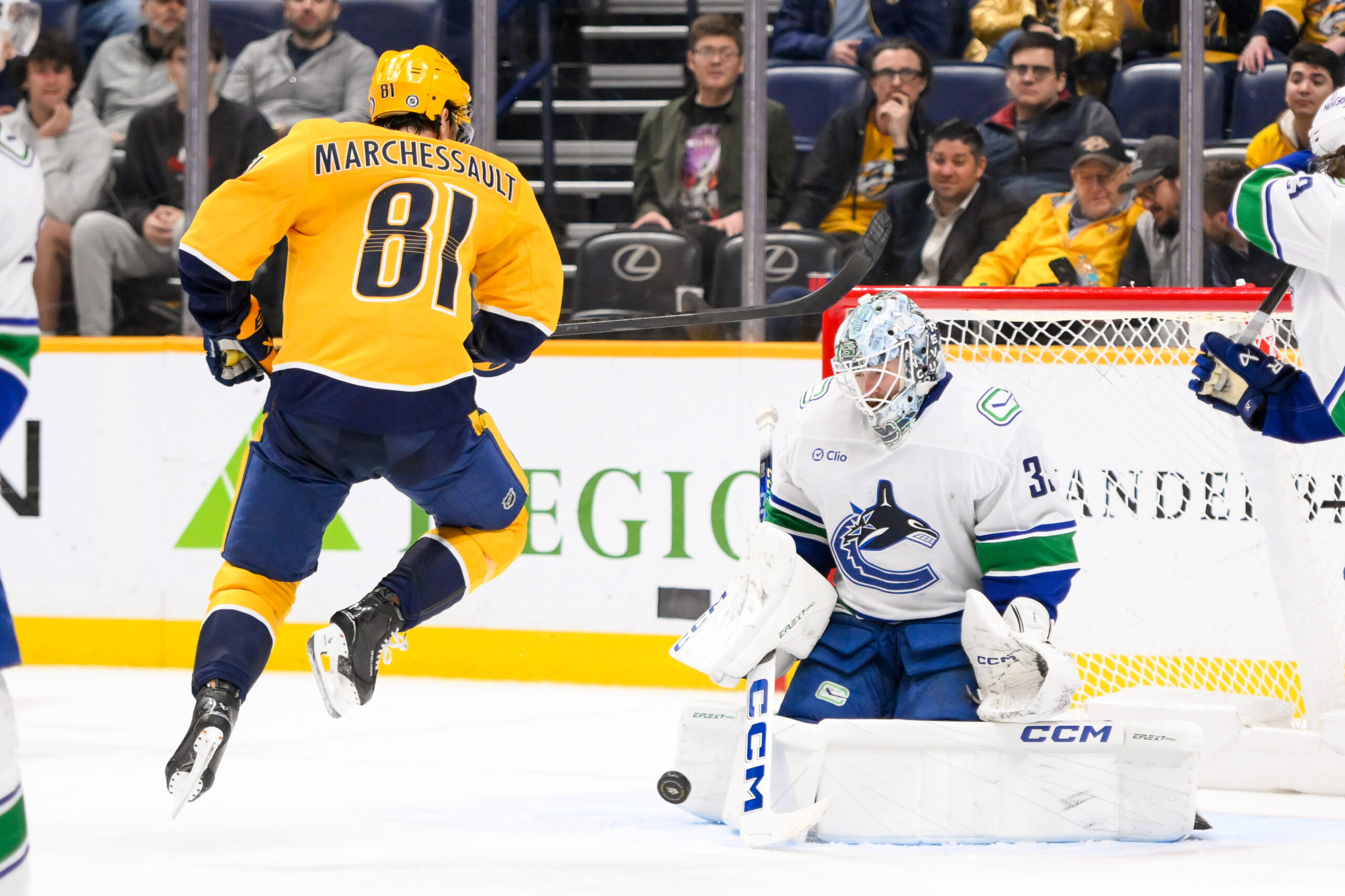 Jan 29, 2025; Nashville, Tennessee, USA;  Vancouver Canucks goaltender Thatcher Demko (35) blocks the shot of Nashville Predators center Jonathan Marchessault (81) during the third period at Bridgestone Arena. Mandatory Credit: Steve Roberts-Imagn Images