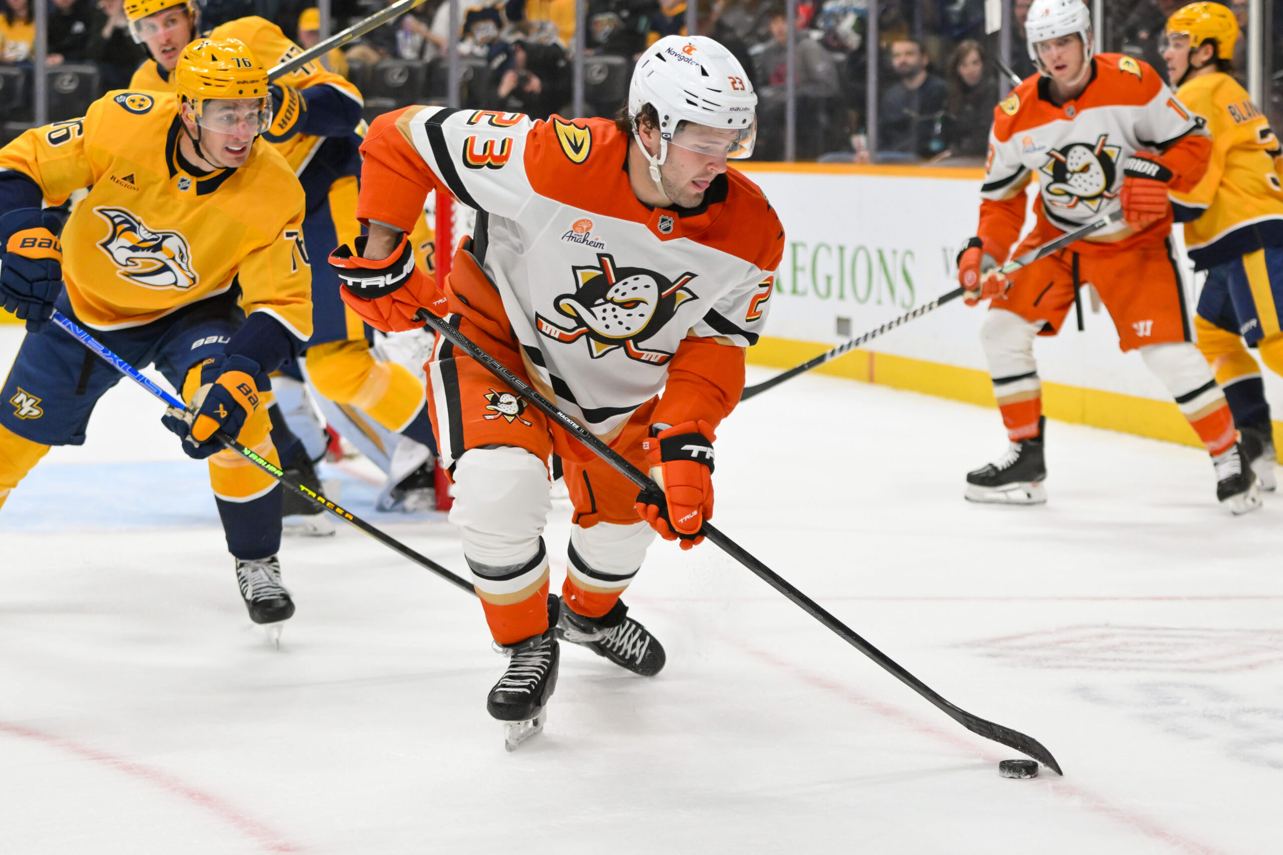Mar 20, 2025; Nashville, Tennessee, USA;  Anaheim Ducks center Mason McTavish (23) skates with the puck against the Nashville Predators during the second period at Bridgestone Arena. Mandatory Credit: Steve Roberts-Imagn Images