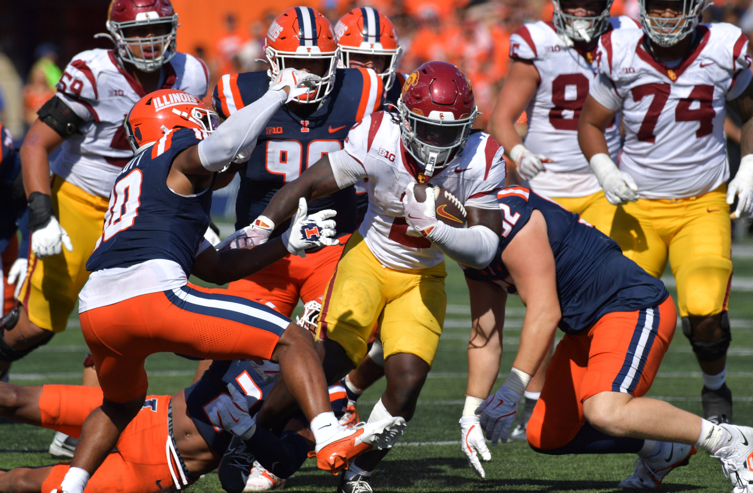 Sep 27, 2025; Champaign, Illinois, USA;  Southern California Trojans running back Waymond Jordan (2) runs through the Illinois Fighting Illini defensive line during the second half at Memorial Stadium. Mandatory Credit: Ron Johnson-Imagn Images