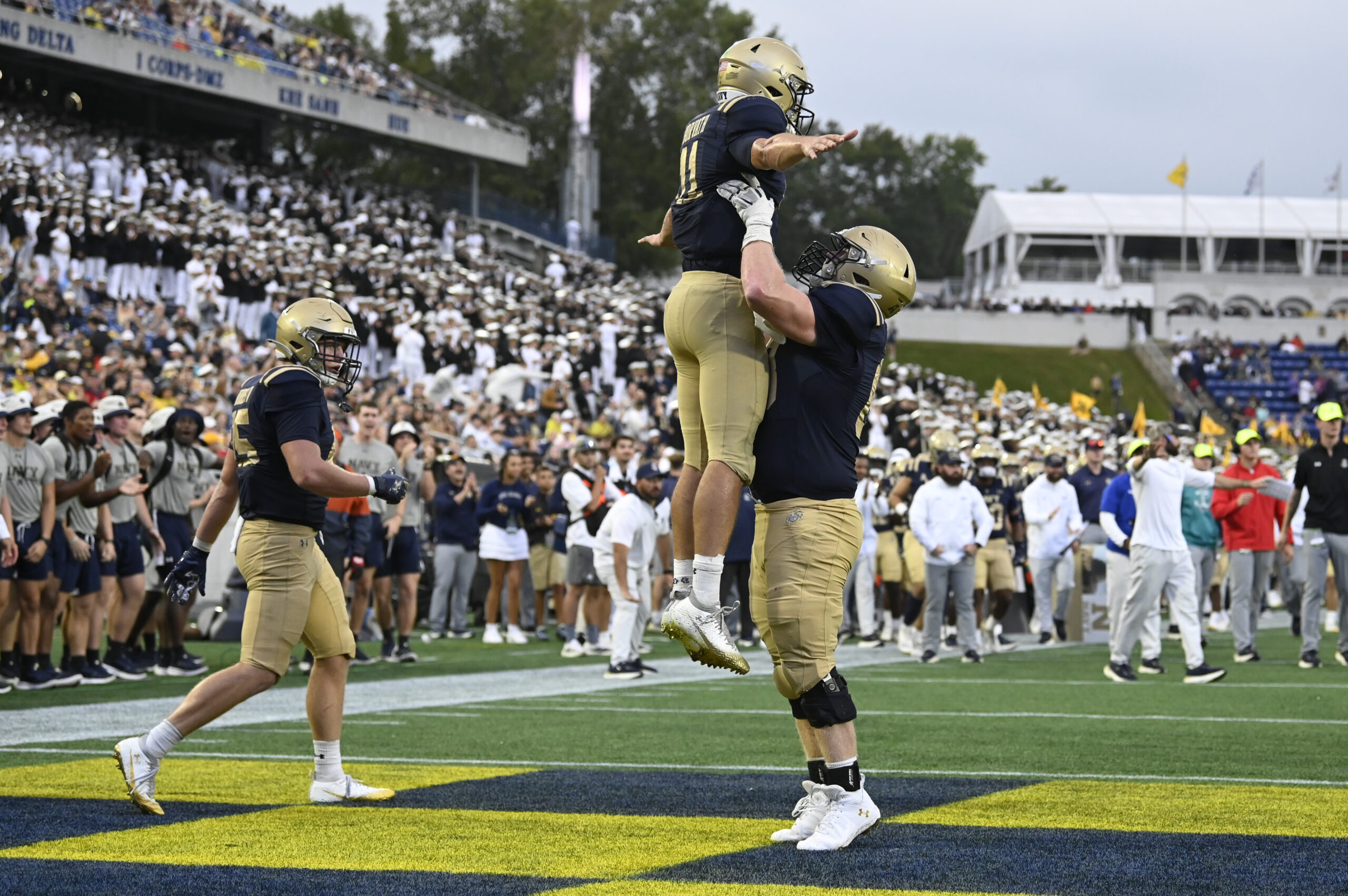 Sep 27, 2025; Annapolis, Maryland, USA;  Navy Midshipmen quarterback Blake Horvath (11) celebrates with  guard Jaylin Acevedo (66) after scoring a fourth quarter touchdown against the Rice Owls at Navy-Marine Corps Memorial Stadium. Mandatory Credit: Tommy Gilligan-Imagn Images