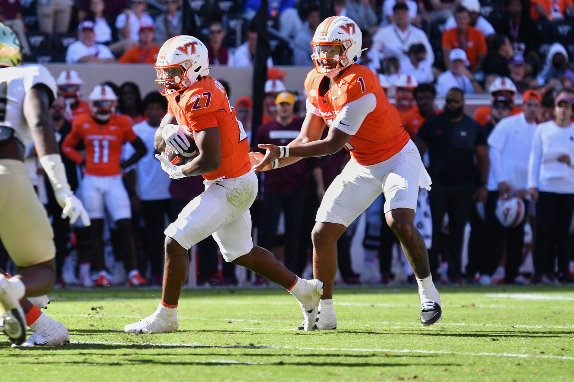 Oct 4, 2025; Blacksburg, Virginia, USA;  Virginia Tech Hokies quarterback Kyron Drones (1) hands the ball to running back Marcellous Hawkins (27) against the Wake Forest Demon Deacons during the third quarter at Lane Stadium. Mandatory Credit: Brian Bishop-Imagn Images