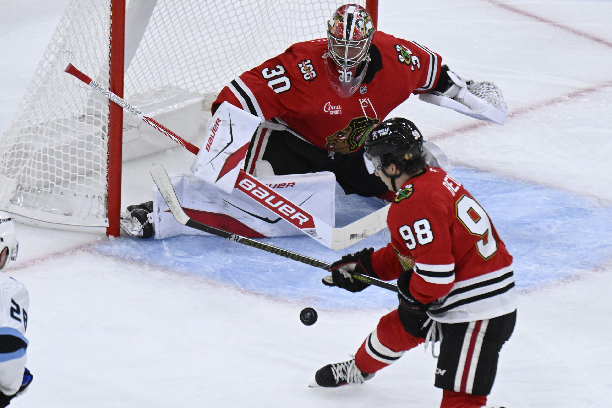 Oct 13, 2025; Chicago, Illinois, USA;  Chicago Blackhawks goaltender Spencer Knight (30) and center Connor Bedard (98) defend against the Utah Mammoth during the second period at United Center. Mandatory Credit: Matt Marton-Imagn Images