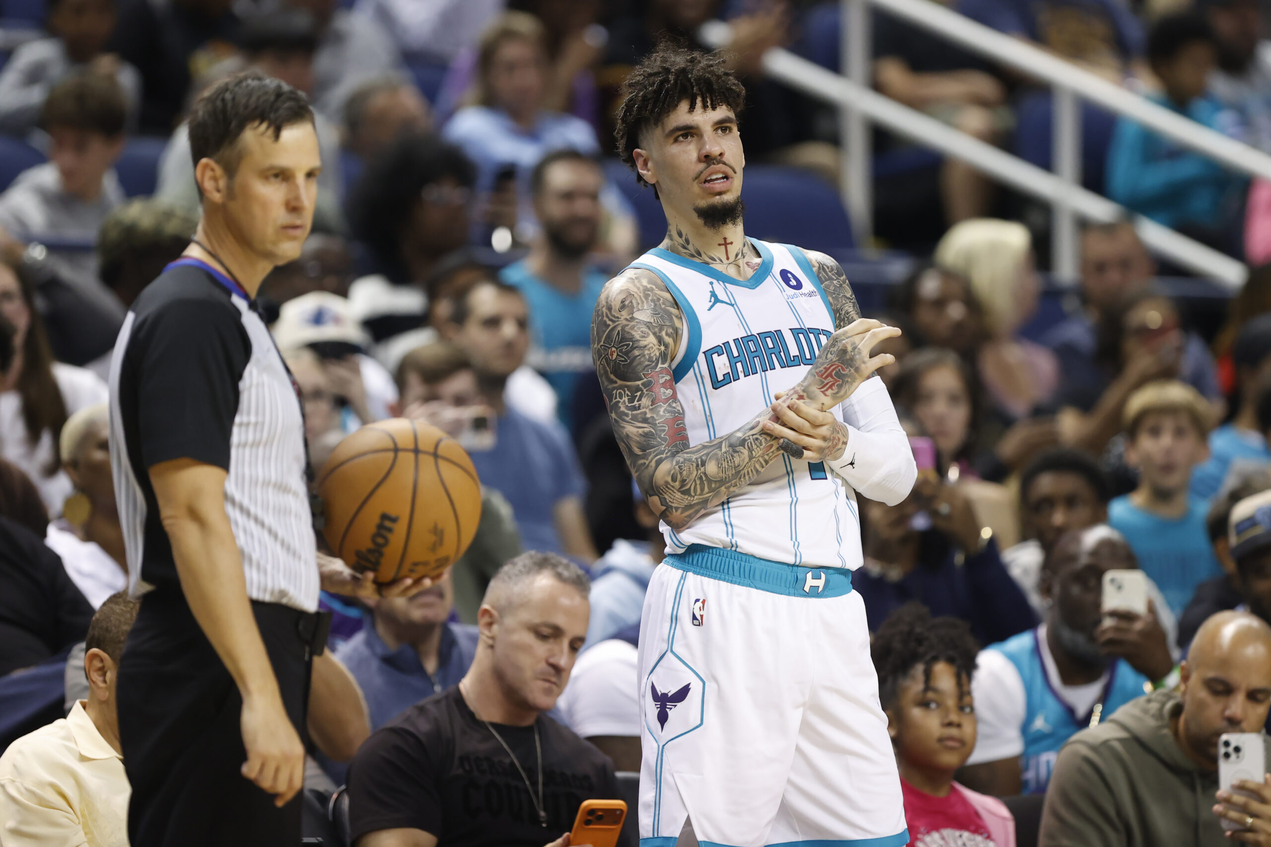 Oct 15, 2025; Greensboro, North Carolina, USA; Charlotte Hornets guard LaMelo Ball (1) rubs his wrist while waiting to inbound the basketball during the second half against the Memphis Grizzlies at First Horizon Coliseum. Mandatory Credit: Brian Westerholt-Imagn Images