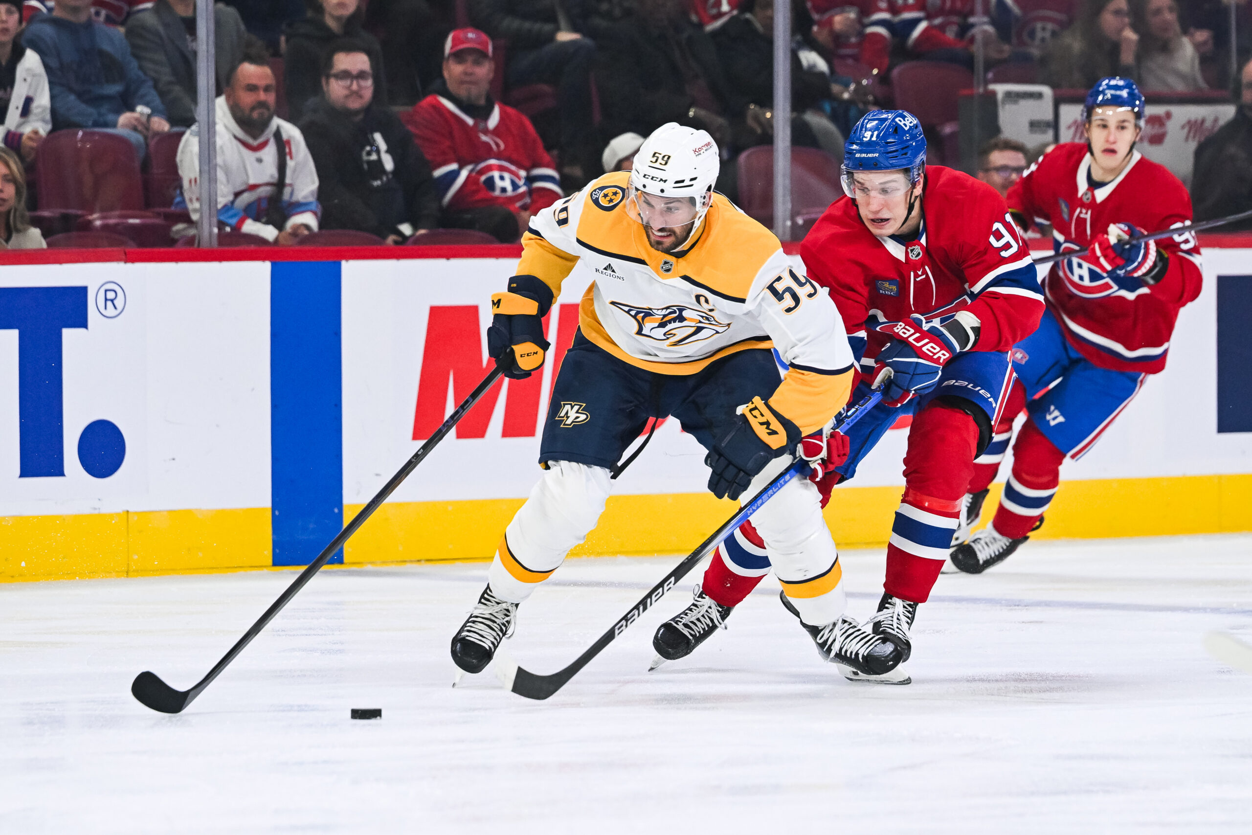 Oct 16, 2025; Montreal, Quebec, CAN; Montreal Canadiens center Oliver Kapanen (91) defends against Nashville Predators defenseman Roman Josi (59) during the first period at Bell Centre. Mandatory Credit: David Kirouac-Imagn Images