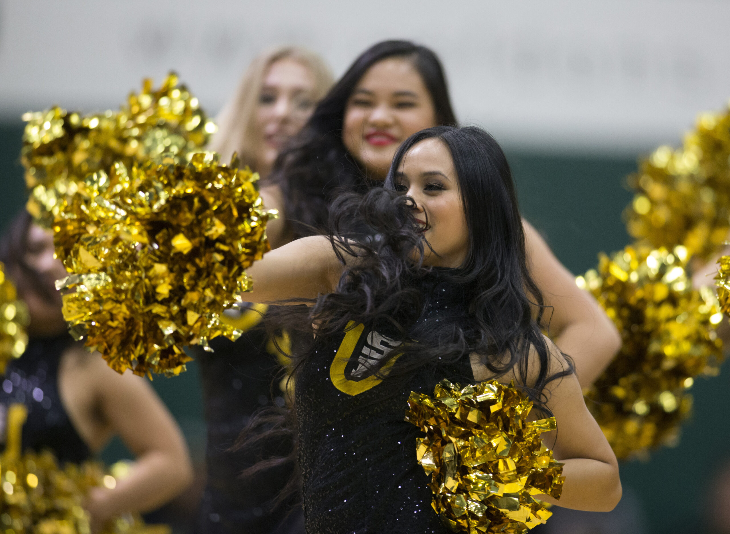 Feb 15, 2018; San Francisco, CA, USA; Cheerleaders entertain the crowd during a timeout in the first half of an NCAA men's college basketball game between the San Francisco Dons and the Saint Mary   s Gaels at War Memorial Gymnasium. Mandatory Credit: D. Ross Cameron-Imagn Images