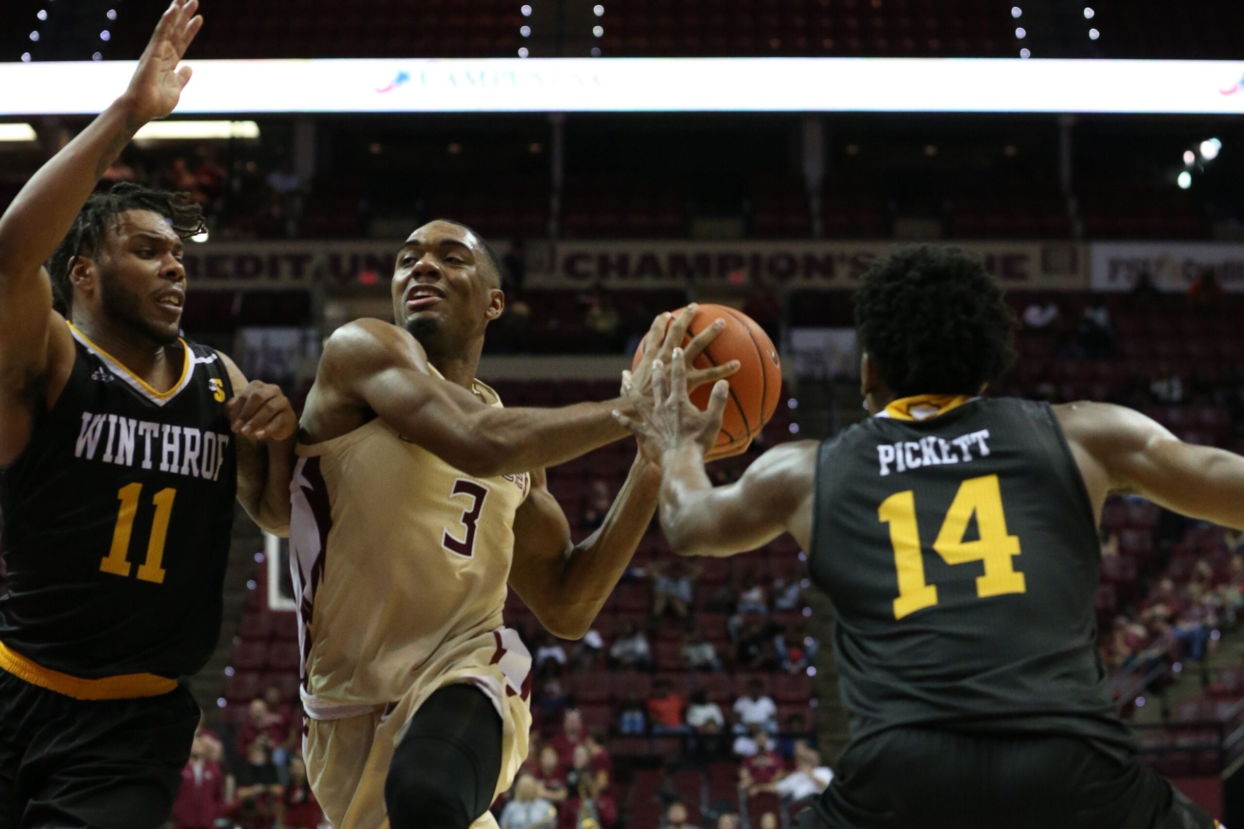 Florida State Seminoles guard Trent Forrest (3) drives the ball to the hoop while Winthrop Eagles guard Charles Falden (11) and Winthrop Eagles guard Adam Pickett (14) try to stop him from scoring. The Florida State Seminoles host the Winthrop Eagles for men's basketball at the Tucker Civic Center, Tuesday, Jan. 1, 2019.

Fsu V Winthrop321