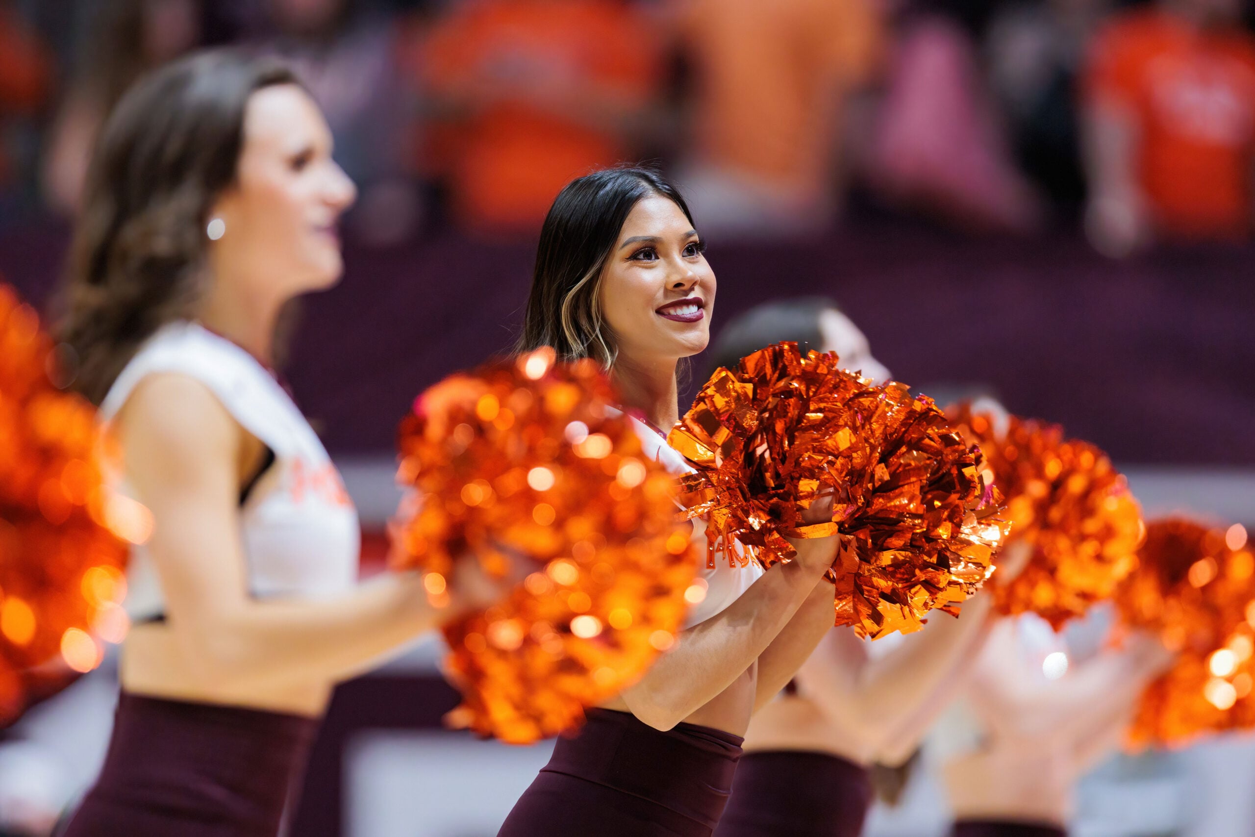 Feb 7, 2022; Blacksburg, Virginia, USA; Virginia Tech Hokies cheerleaders perform during the first half of an NCAA college basketball game against the Pittsburg Panthers at Cassell Coliseum. Mandatory Credit: Ryan Hunt-Imagn Images