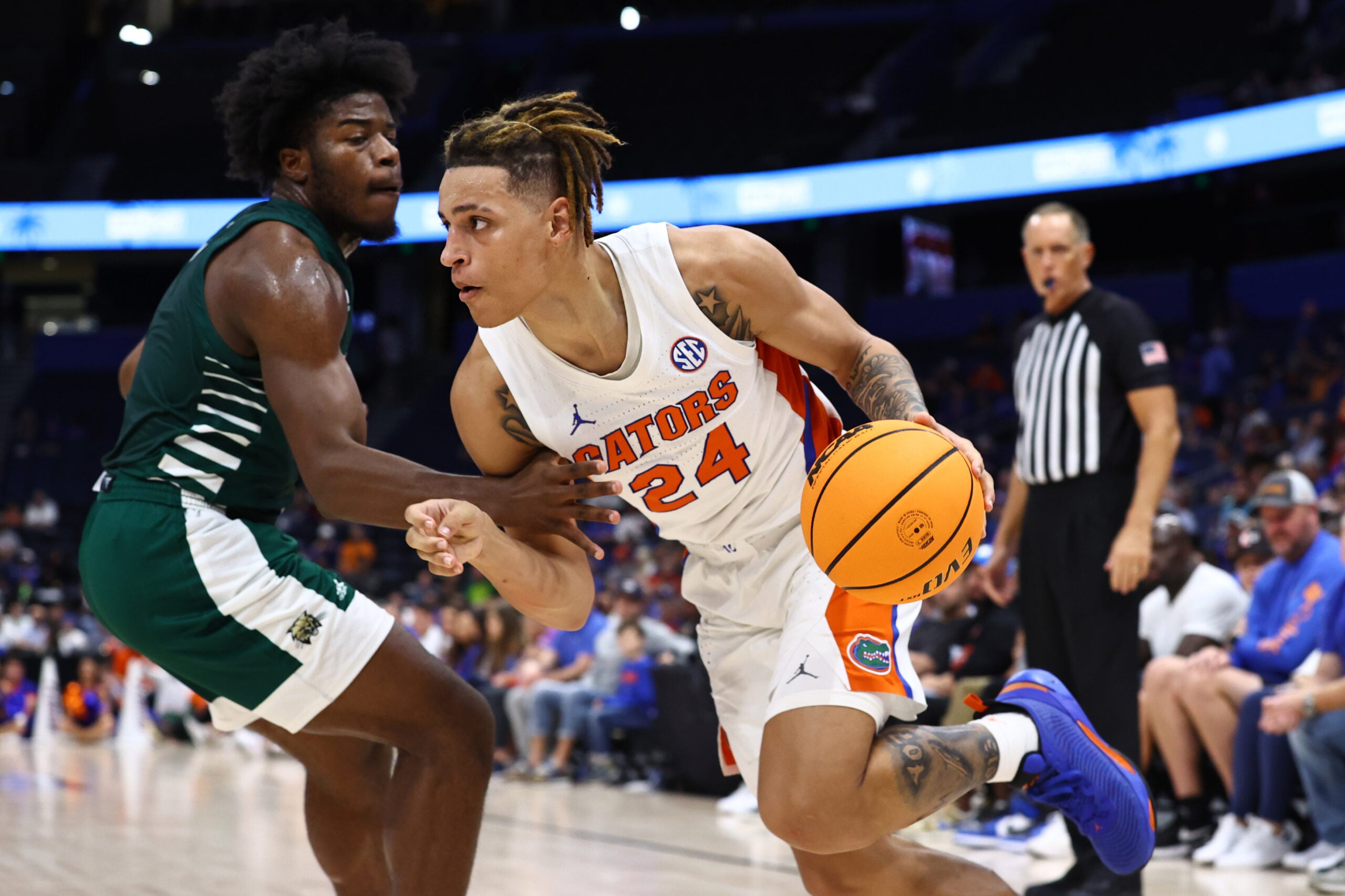 Dec 14, 2022; Tampa, Florida, USA;Florida Gators guard Riley Kugel (24) drives to the basket as Ohio Bobcats guard Elmore James (1) defends  during the second half at Amalie Arena. Mandatory Credit: Kim Klement-Imagn Images
