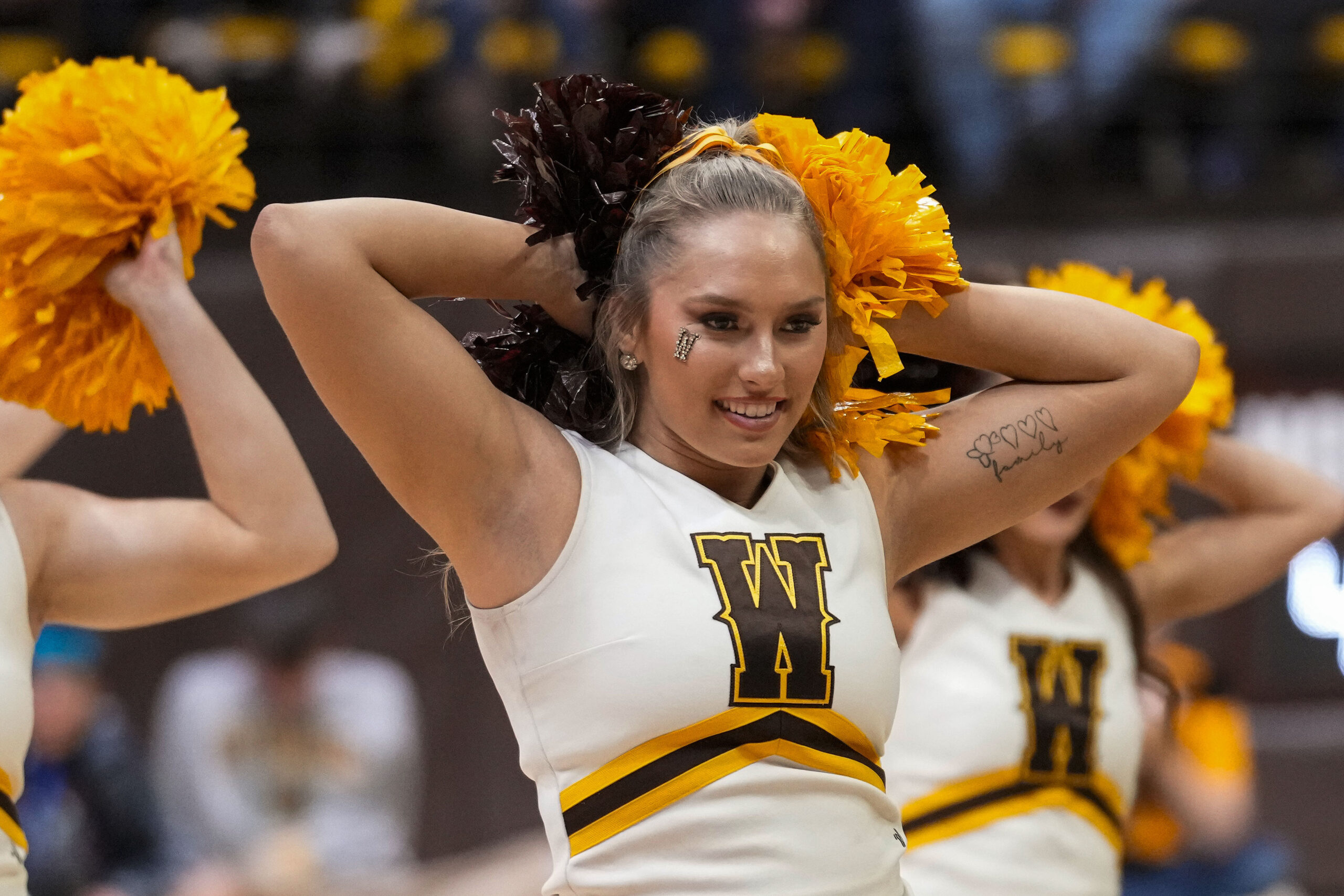 Feb 24, 2024; Laramie, Wyoming, USA; A Wyoming Cowboys cheerleader performs against Boise State Broncos during the second half at Arena-Auditorium. Mandatory Credit: Troy Babbitt-Imagn Images