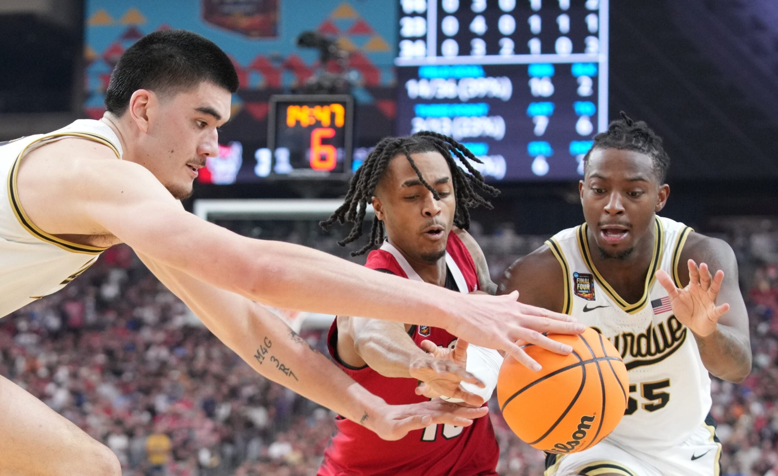 Purdue Boilermakers center Zach Edey (15), North Carolina State Wolfpack guard Breon Pass (10) and Purdue Boilermakers guard Lance Jones (55) go for the ball during the NCAA Menâ€™s Basketball Tournament Final Four game, Saturday, April 6, 2024, at State Farm Stadium in Glendale, Ariz.