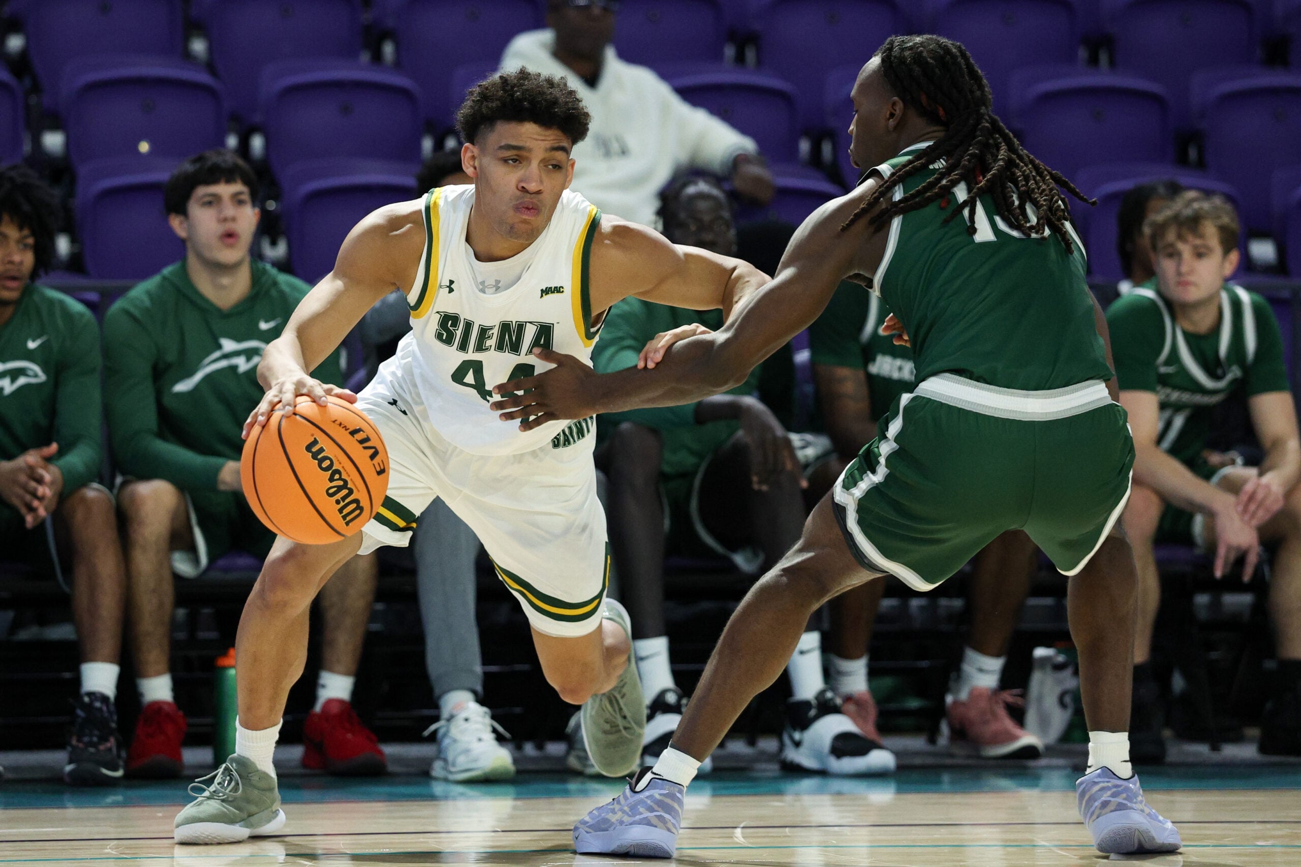 Nov 26, 2024; Fort Myers, Florida, USA; Siena Saints guard Marcus Jackson (44) is guided by Jacksonville Dolphins guard Robert McCray V (13) in the first half at Suncoast Credit Union Arena. Mandatory Credit: Nathan Ray Seebeck-Imagn Images
